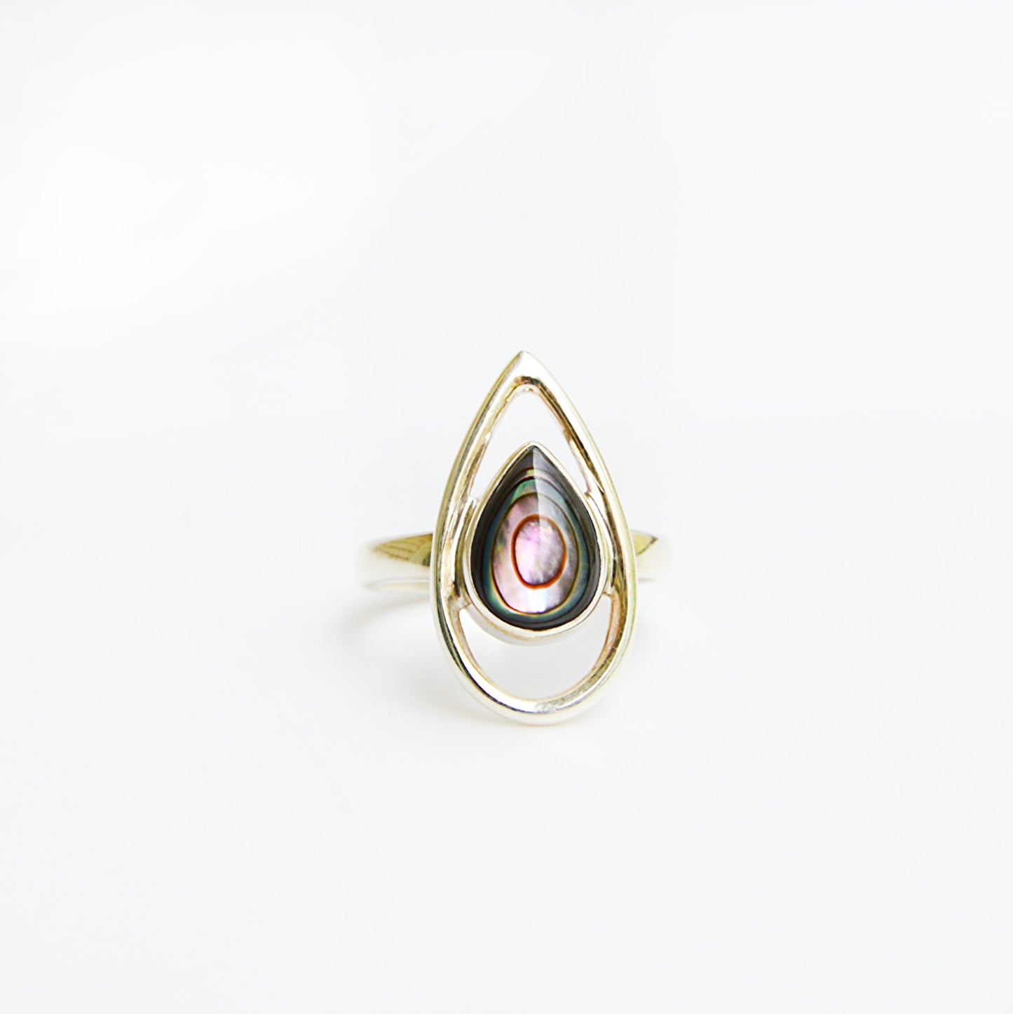 Striking abalone ring by JeniMarie Jewelry showcasing the luminous glow of the abalone shell. set in sterling silver and the band is a comfort fit band.
