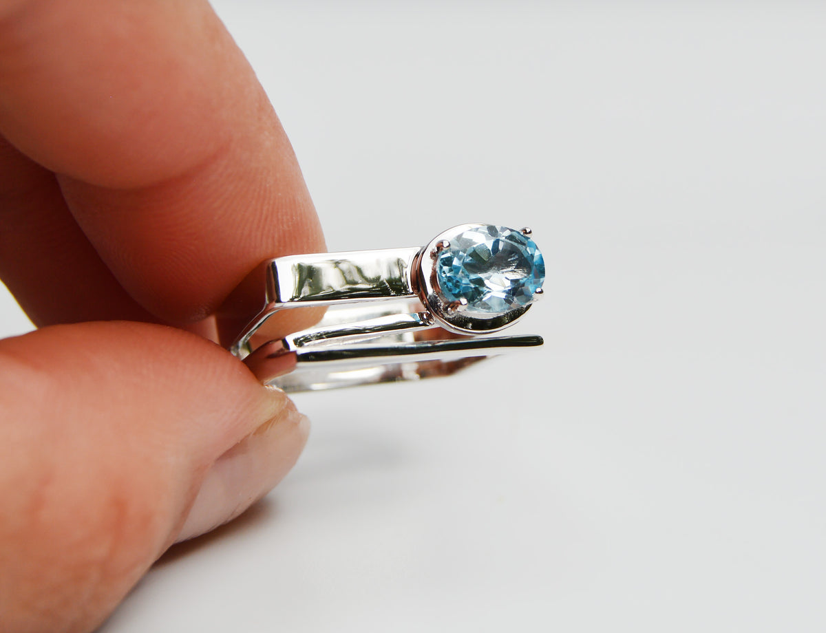 JeniMarie Jewelry with a rare square ring with a bright blue topaz prong set stone.