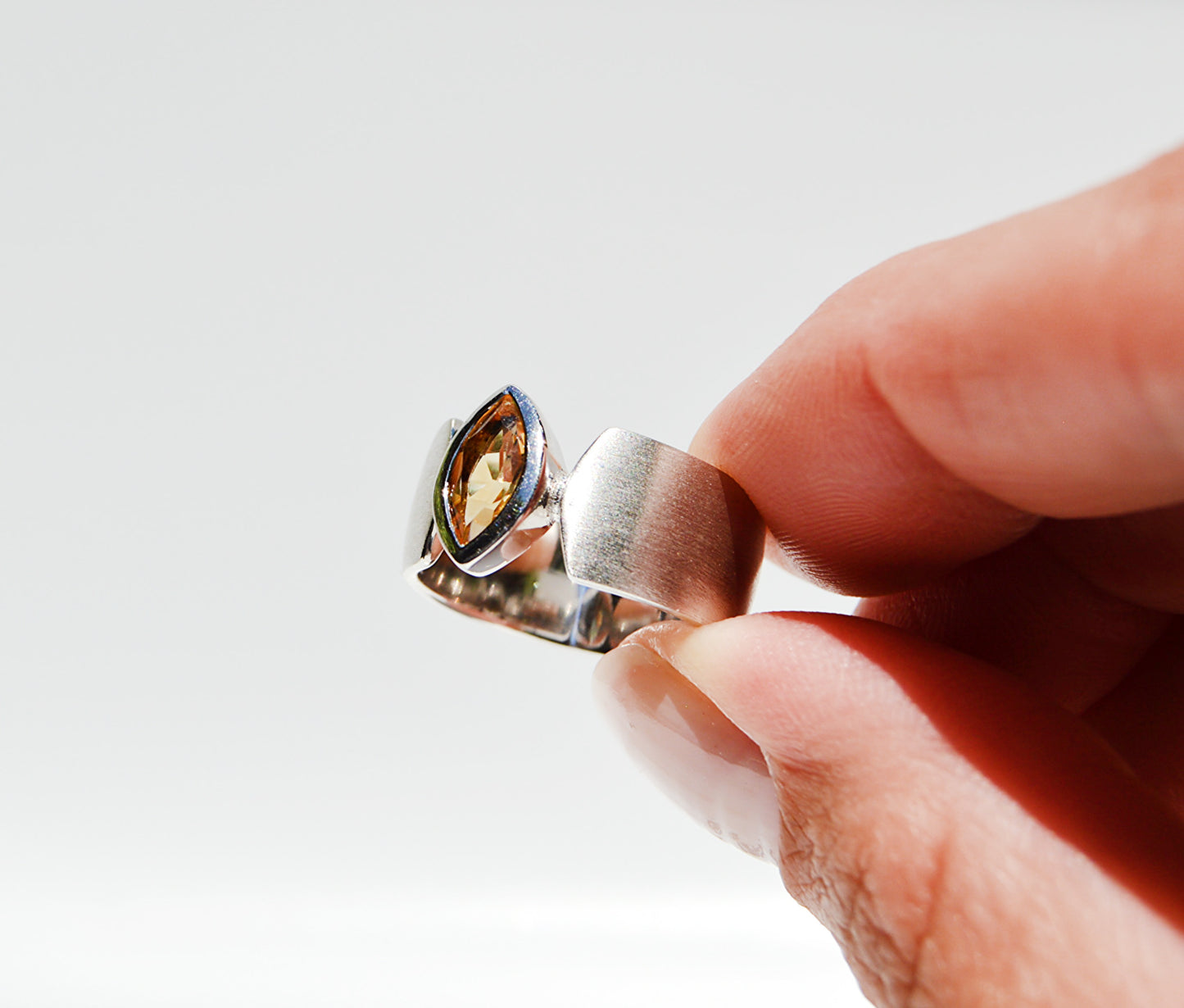 JeniMarie Jewelry with a large and rare citrine ring with a high end and unique look. Set in sterling silver with a brushed look band.