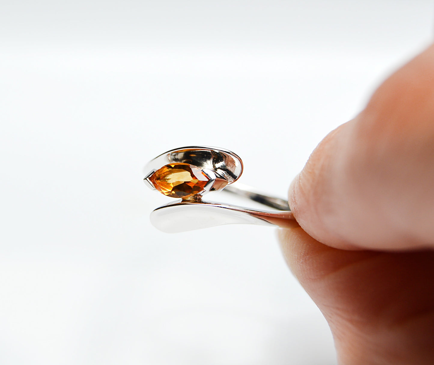JeniMarie Jewelry with a yellow citrine stone set in a rare wave style band. Set in sterling silver for a high polish.
