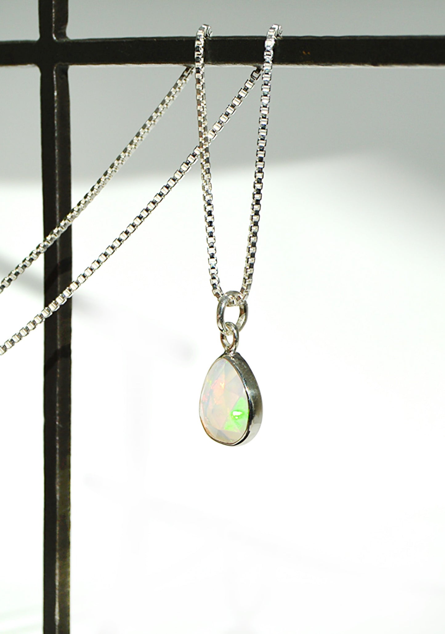 Necklace with an opal pendant on a white background