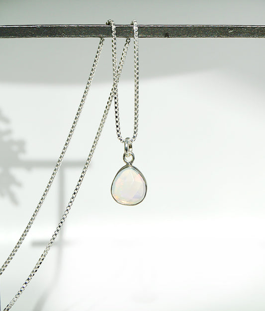 Necklace with a pendant on a light background