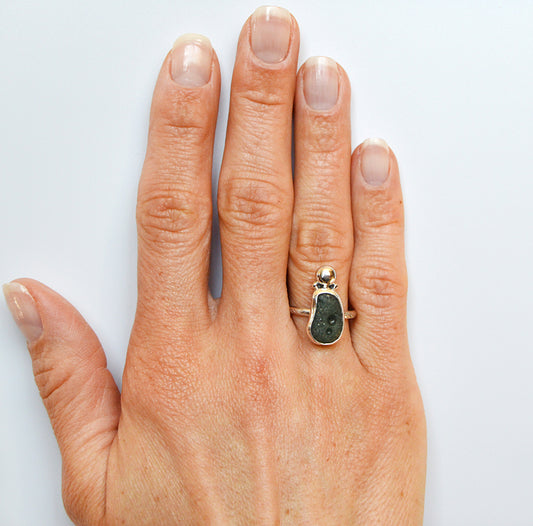 Leelanau blue rare stone unique to Michigan is handset in a fine silver bezel with an accent silver piece on top.