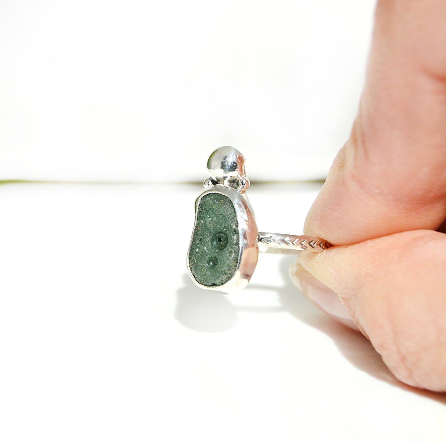 Custom and cool Leelanau Blue stone featured with a textured band using both fine silver and sterling silver.