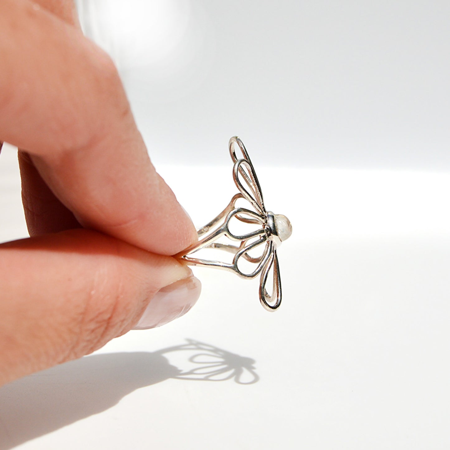 JeniMarie Jewelry showing a trendy unique moonstone ring with a flower design and offered in .925 sterling silver.