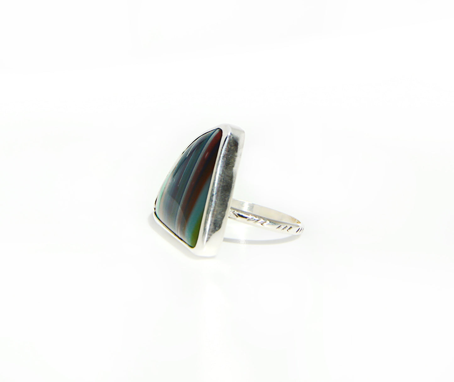 super cool unique and fun ring using a surfite stone which was handset in a fine silver bezel and features a textured designed band.
