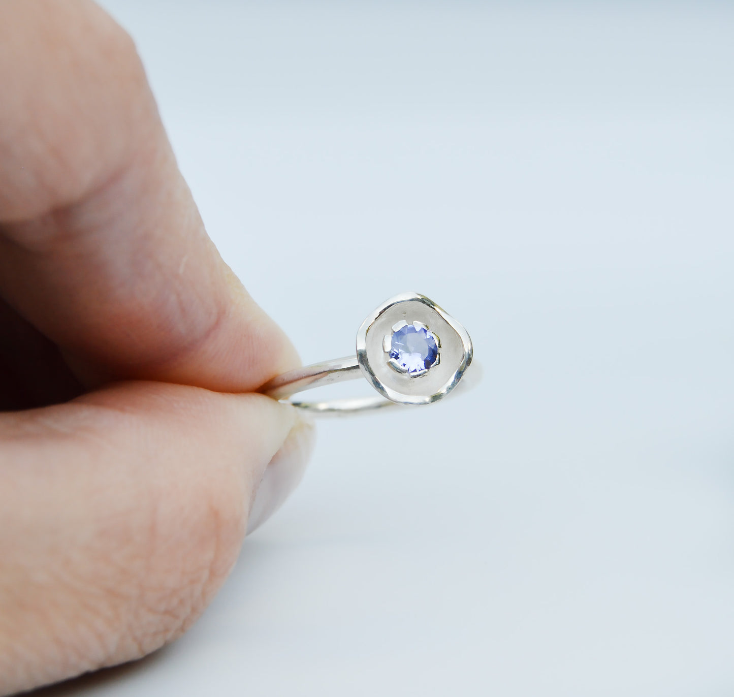 JeniMarie with a cool and fun looking flower ring using a purple tanzanite made in sterling silver.