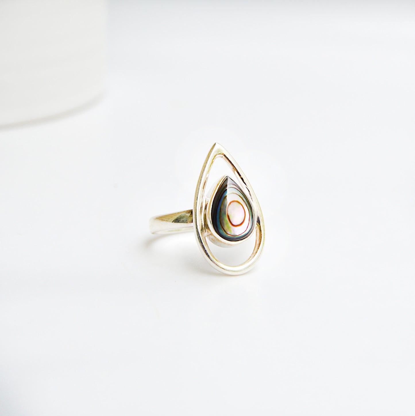 JeniMarie Jewelry abalone ring set in polished sterling silver with an accent border around the stone. 