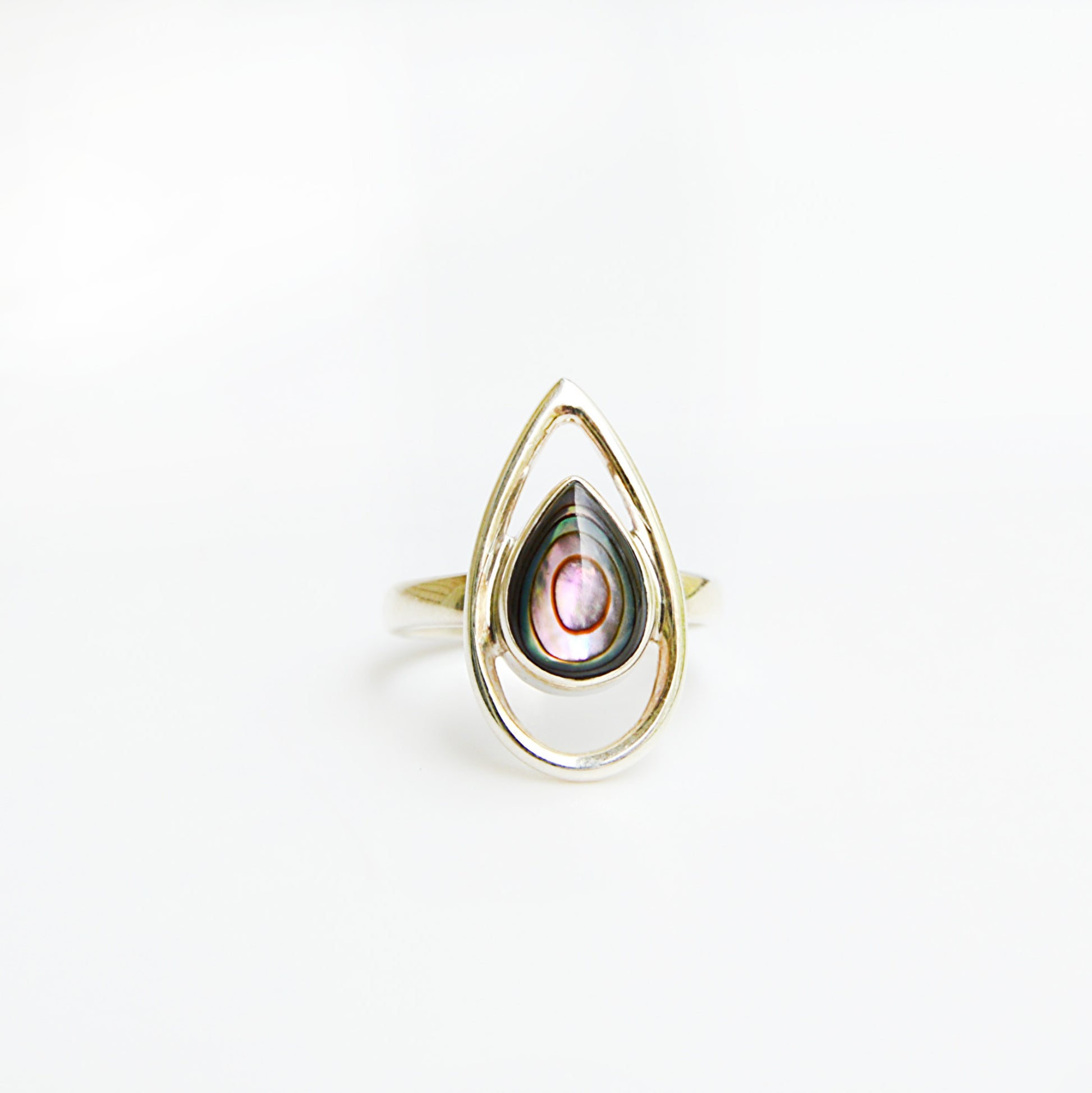 Striking abalone ring by JeniMarie Jewelry showcasing the luminous glow of the abalone shell. set in sterling silver and the band is a comfort fit band. 