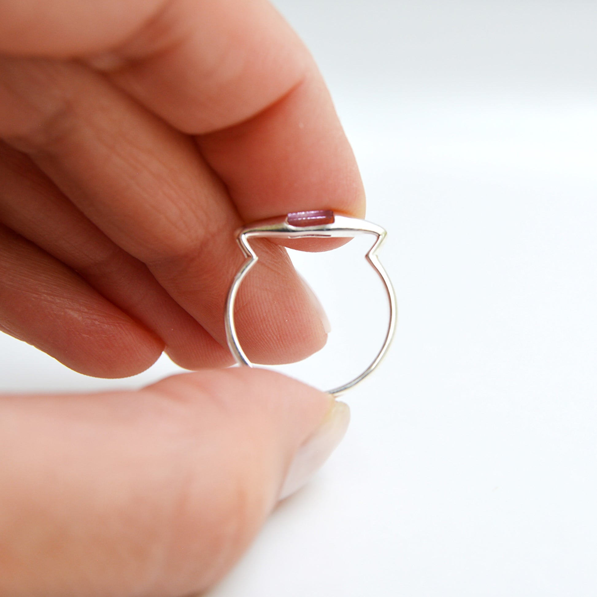 JeniMarie Jewelry  with an amethyst tension set ring. Unique design with a comfort band all set in .925 sterling silver making the ring hypoallergenic. 