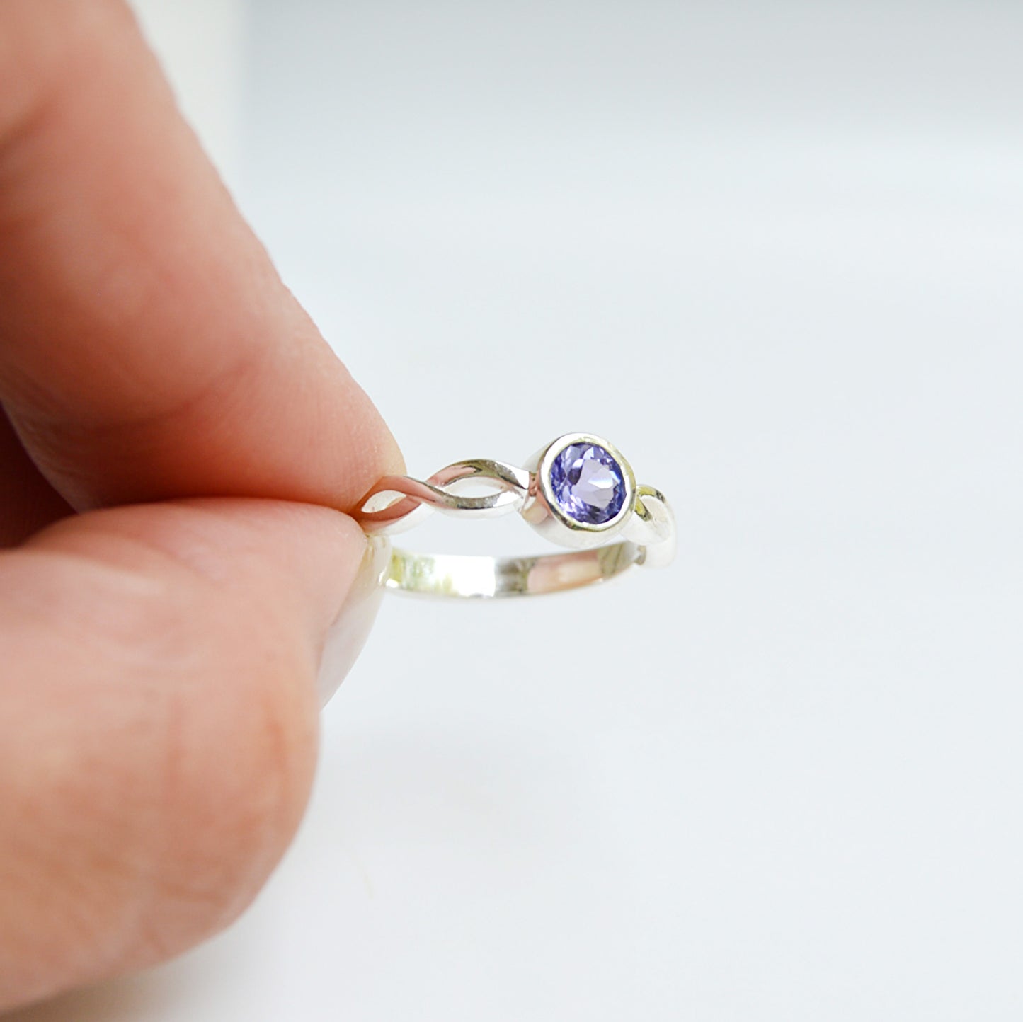 JeniMarie Jewelry tube set amethyst ring featuring a braided band. Set in hypoallergenic sterling silver with a comfort band. 