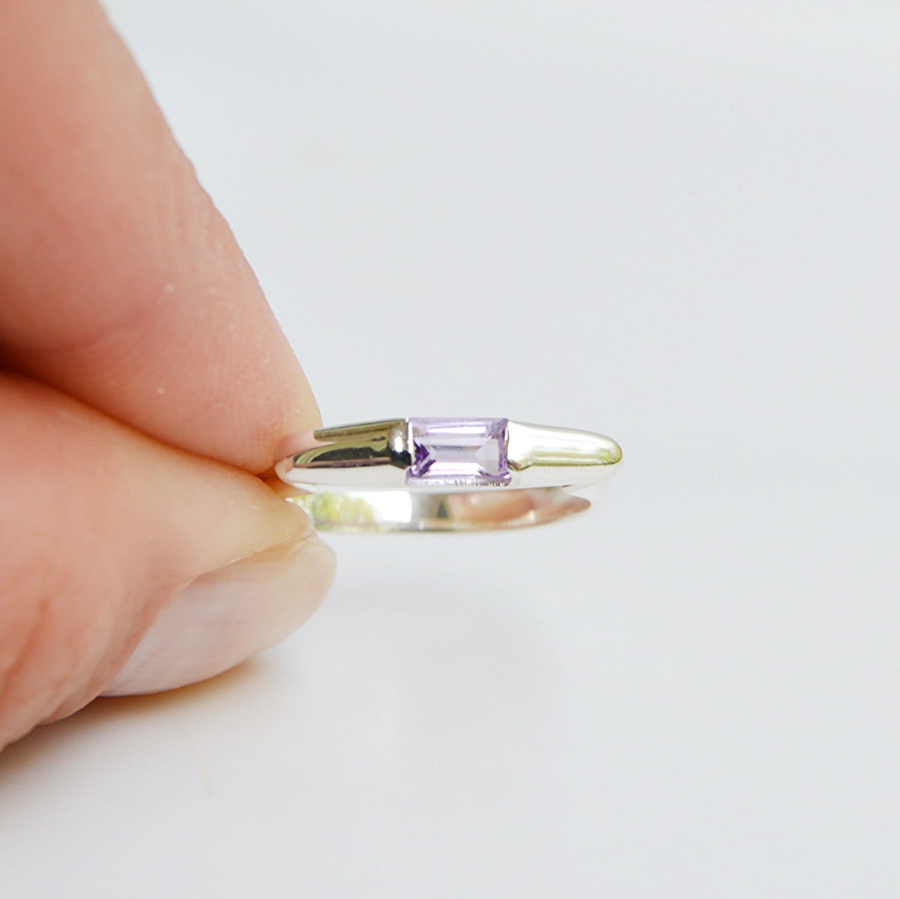 JeniMarie Jewelry presents a tension set amethyst ring set in .925 sterling silver. 