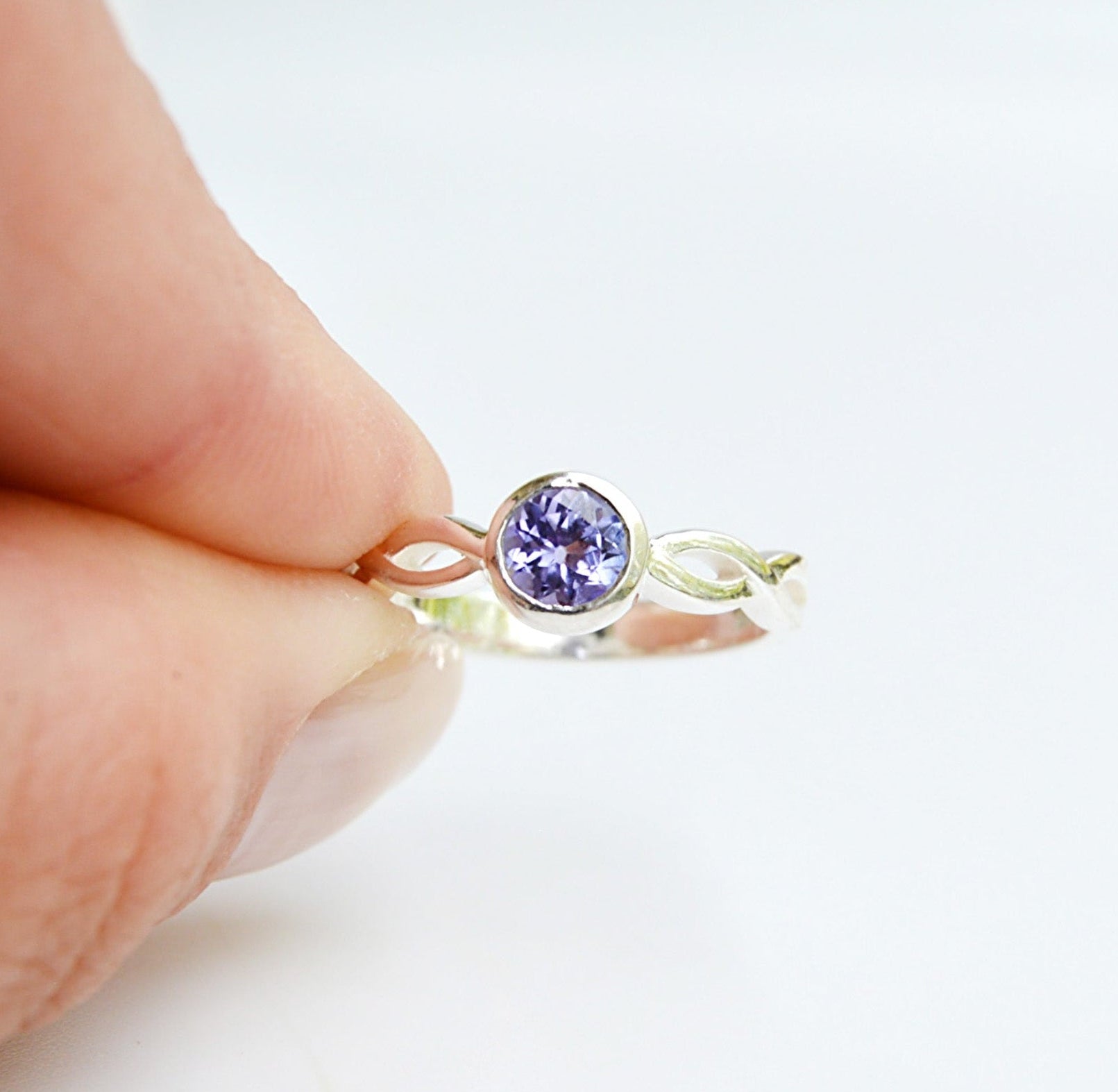 Jenimarie Jewelry sterling silver amethyst ring with a braided band. the tube set ring features a comfort band while being hypoallergenic. 