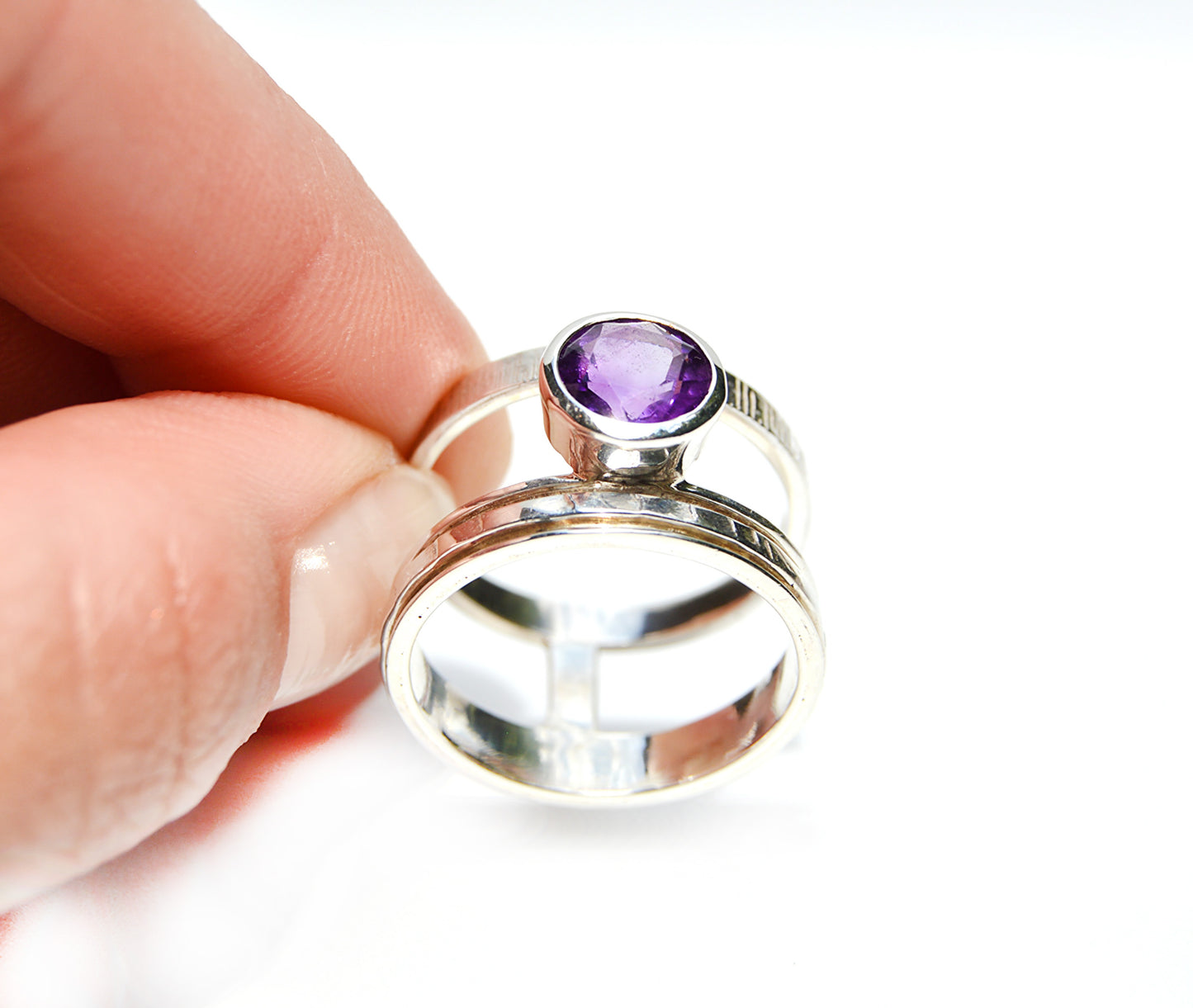JeniMarie Jewelry with a one of a kind ring with a double band and amethyst stone with a spinner ring. 
