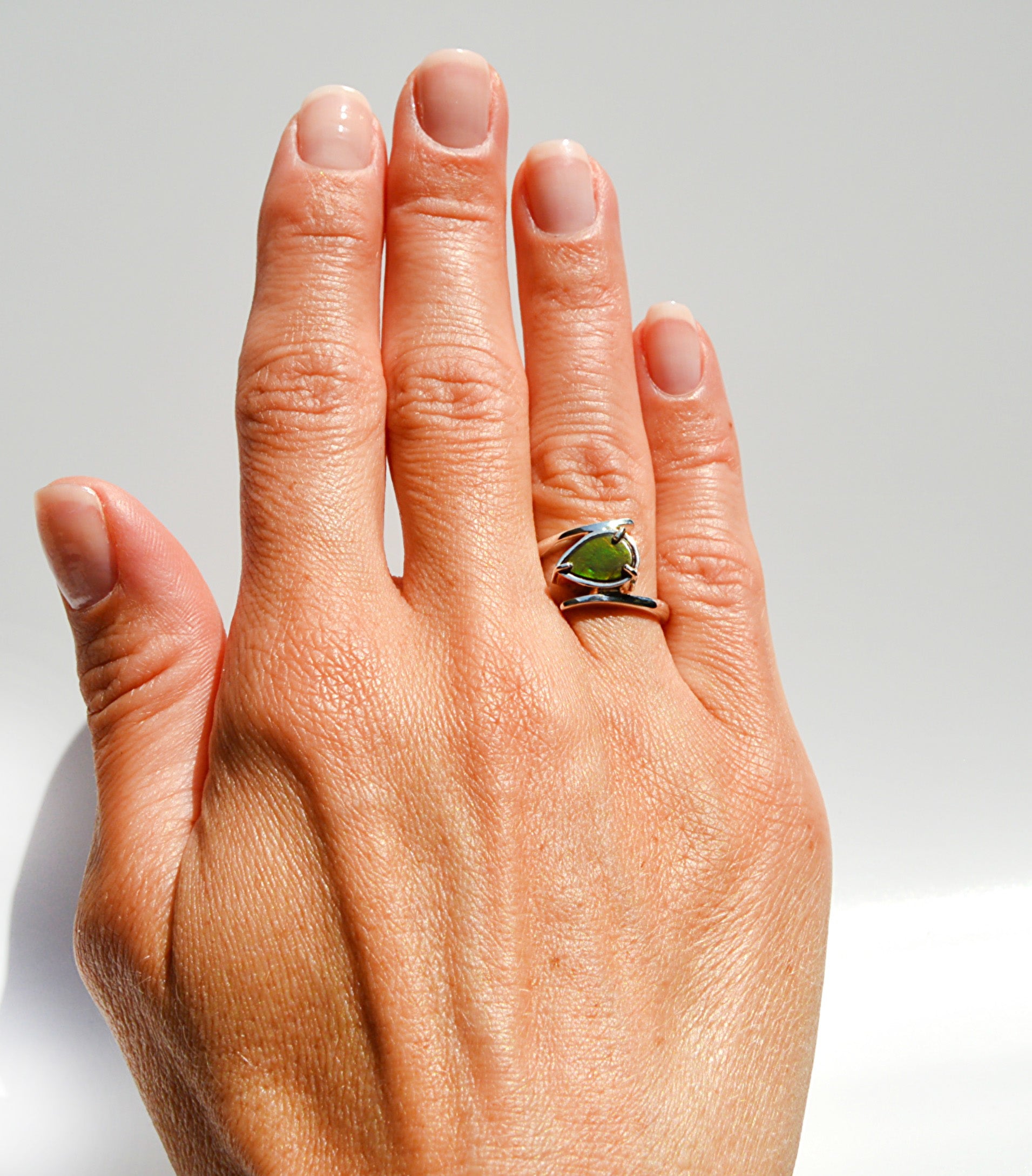 JeniMarie Jewelry with a rare and unique ammolite ring set in sterling silver with a high polish for a bright shine. 