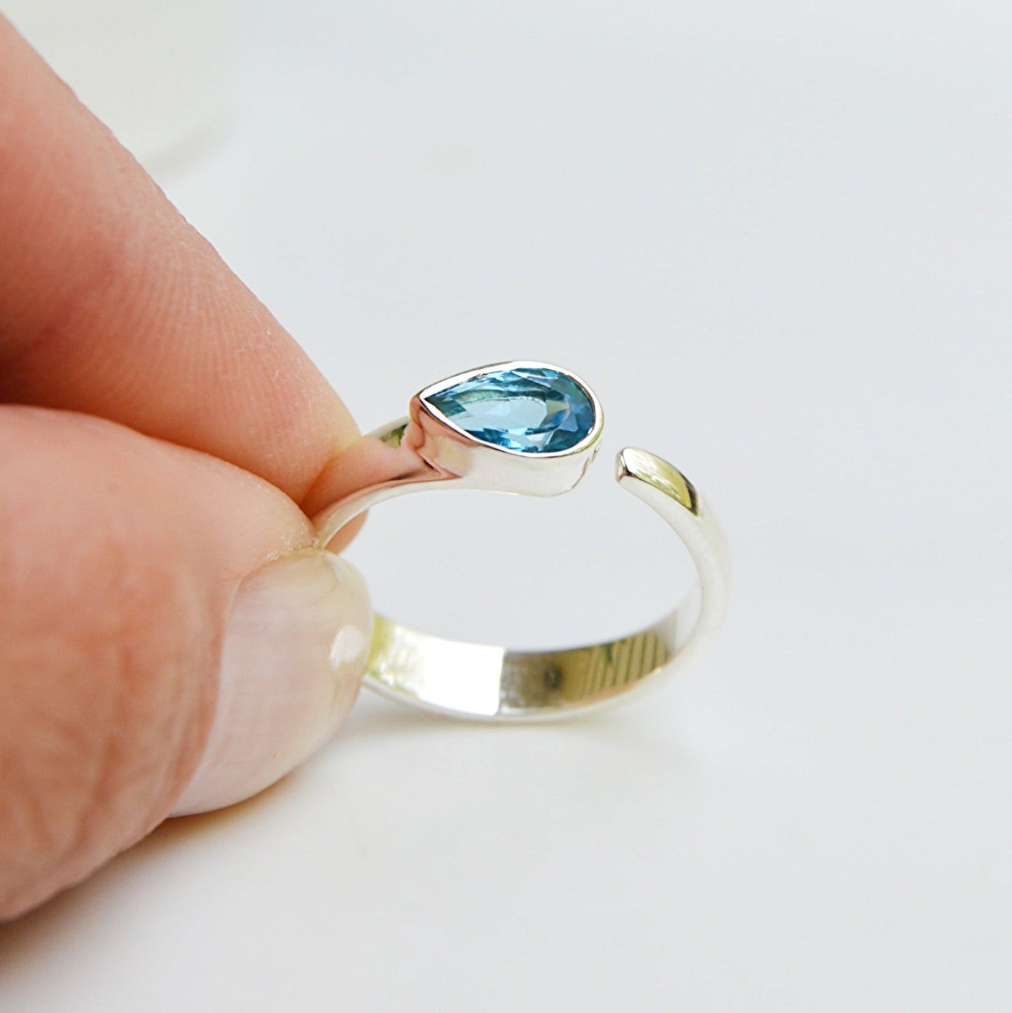 JeniMarie Jewelry features a tube set blue topaz ring set in .925 sterling silver. 