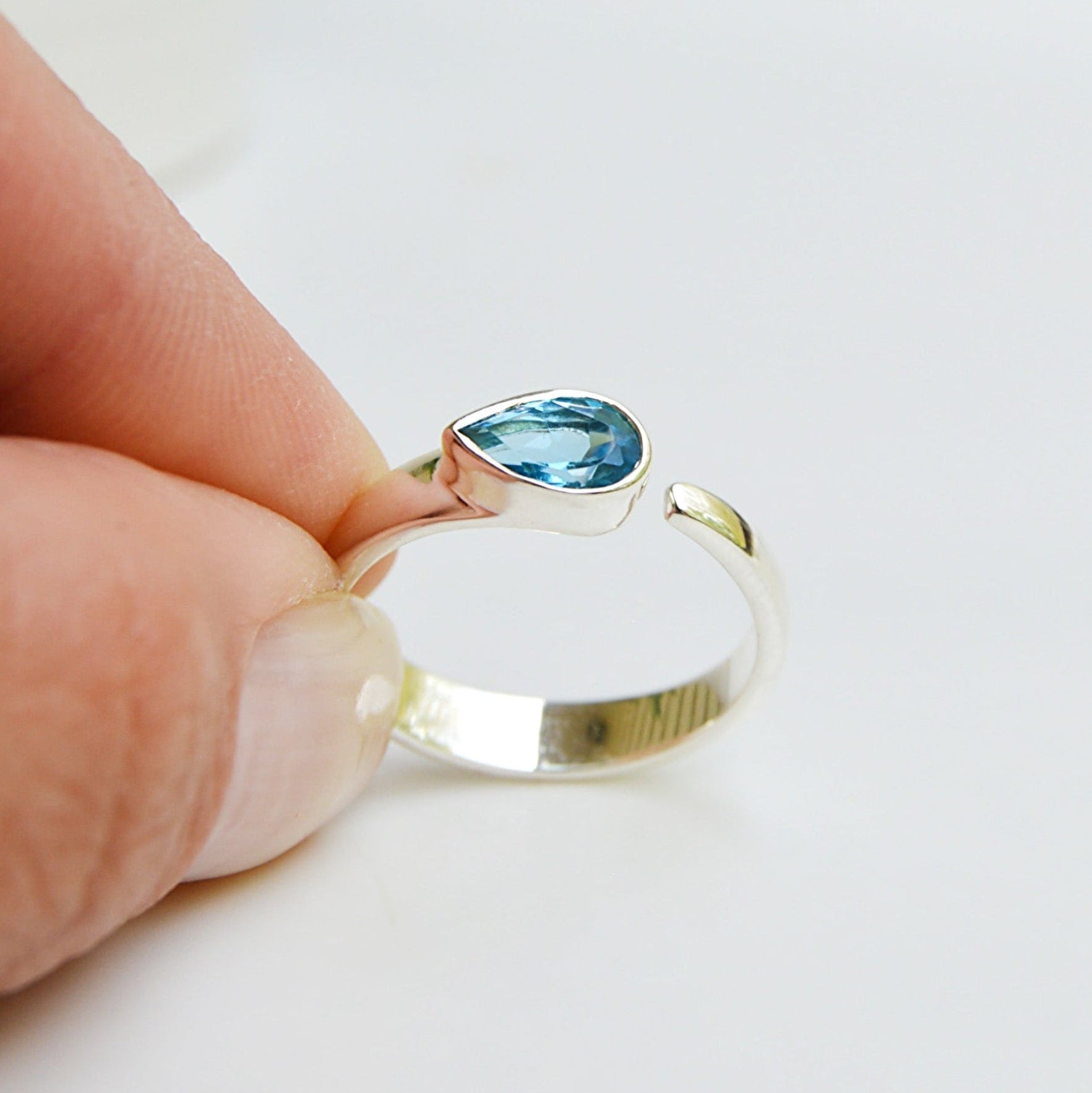 JeniMarie Jewelry features a tube set blue topaz ring set in .925 sterling silver. 