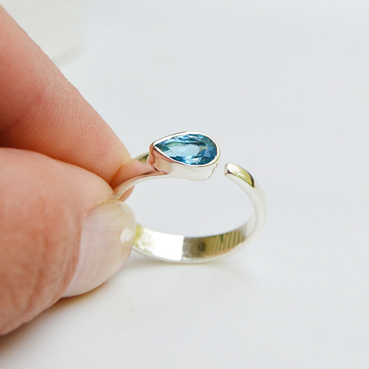 JeniMarie Jewelry features a tube set blue topaz ring set in .925 sterling silver. 