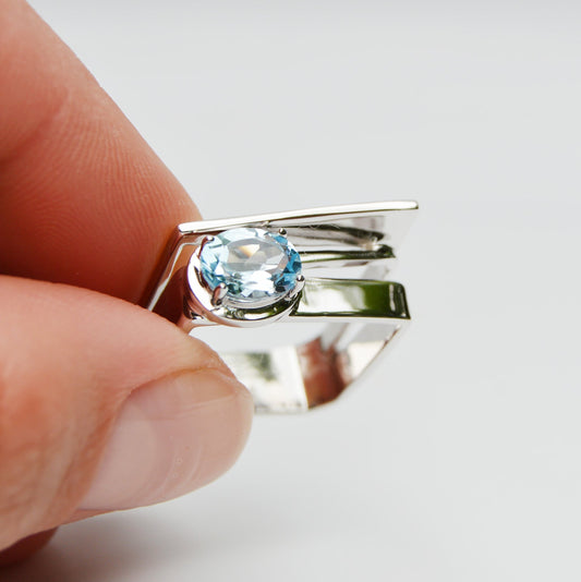 Handmade ring from JeniMarie Jewelry with a blue topaz prong set stone and .925 sterling silver. 
