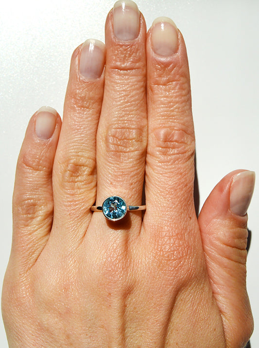 handmade sterling silver ring with a tube set blue topaz stone