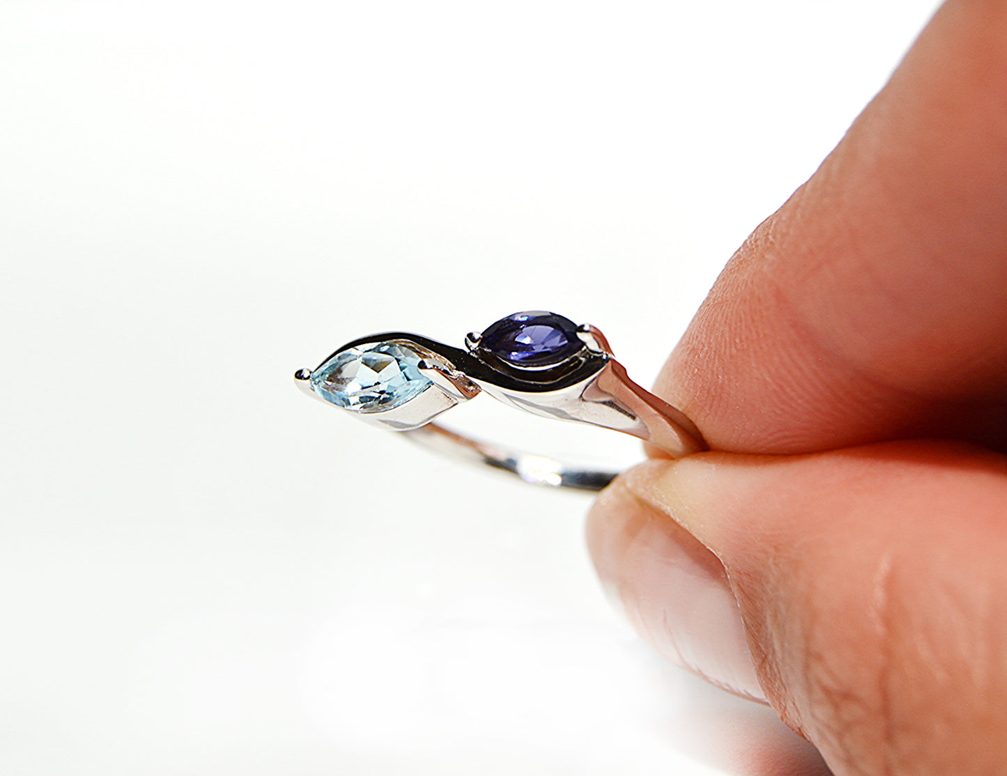 JeniMarie Jewelry with a statement ring featuring blue topaz and tanzanite, blue and purple stones set in sterling silver for a high polish. 