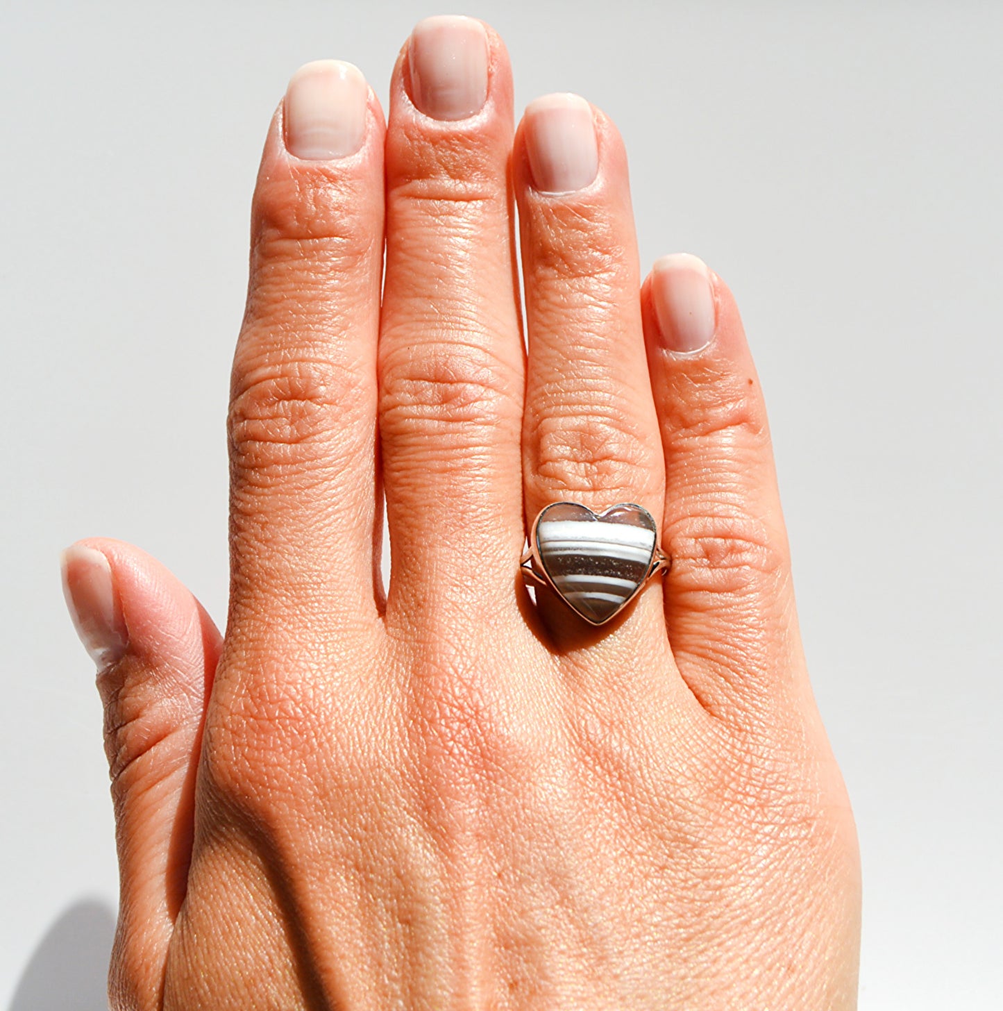 JeniMarie Jewelry with a trendy and cool looking blue opal ring in the shape of a heart. Striking stripes make this piece one of a kind and unique piece. 