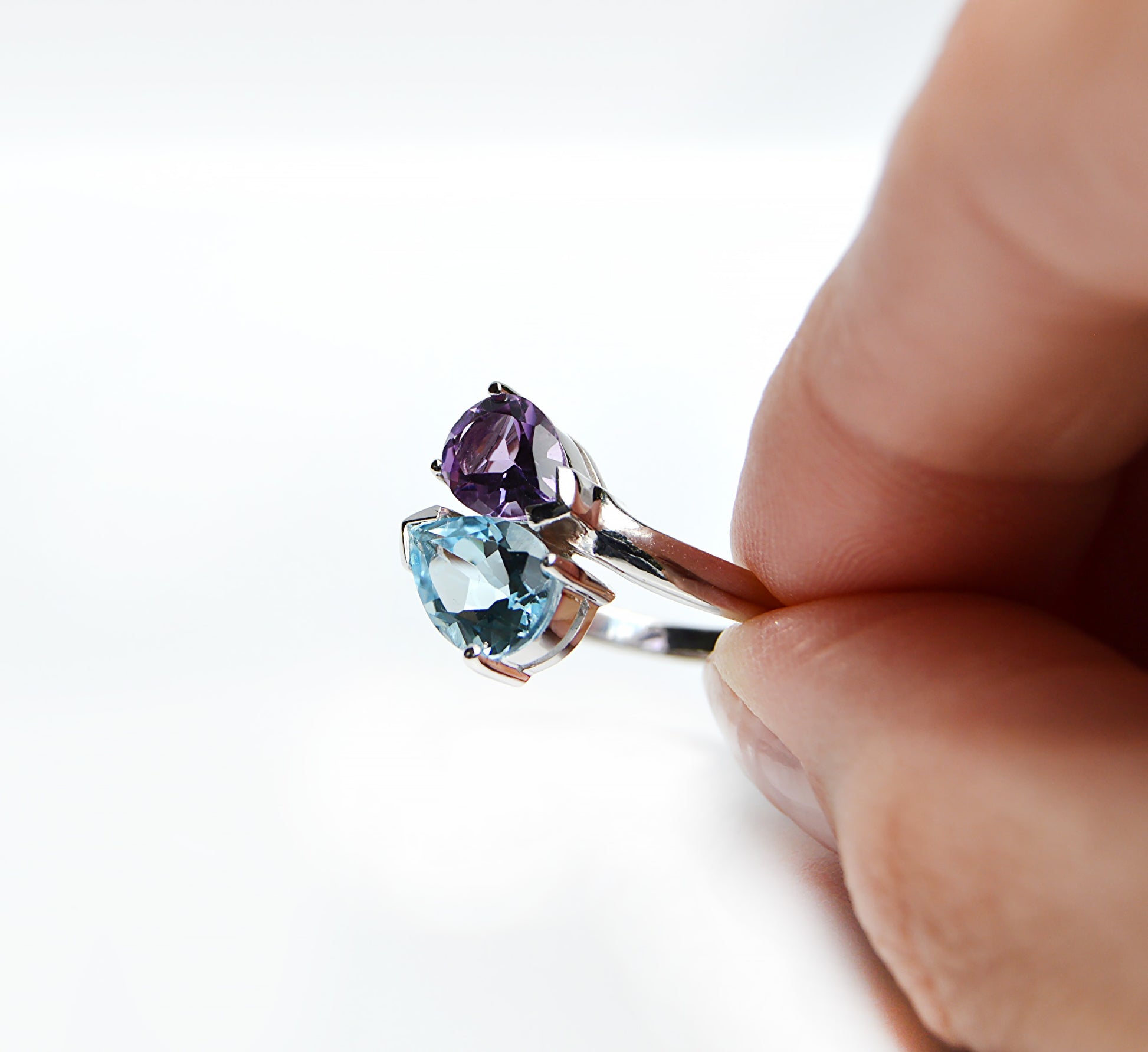 JeniMarie Jewelry with a one of a kind rare two stone ring with a blue topaz and purple amethyst prong set design in sterling silver. 