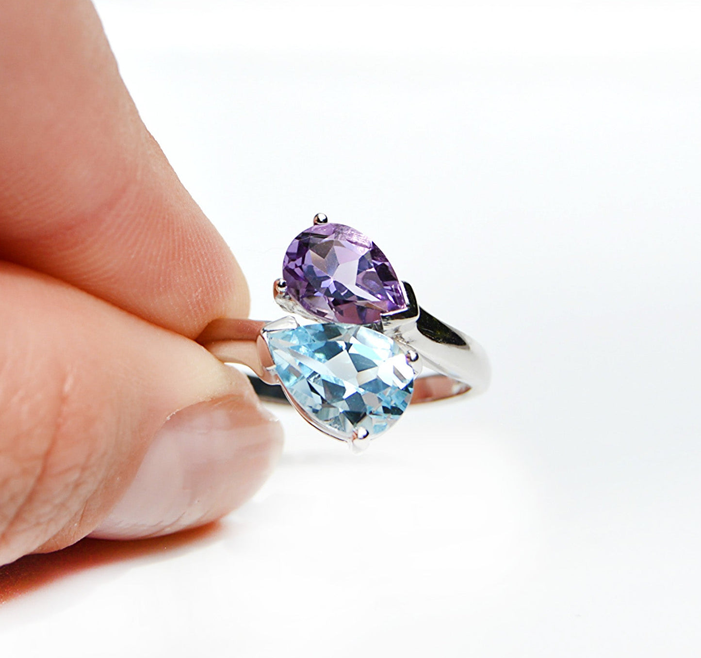 JeniMarie Jewelry with a statement ring  with a purple amethyst and blue topaz prong set ring with a high shine polish all set in sterling silver. 