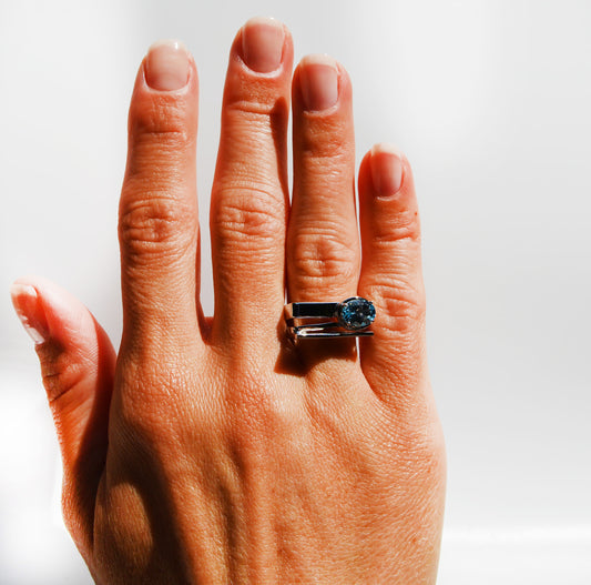 JeniMarie Jewelry with a one of a kind handmade sterling silver ring with a prong set blue topaz stone. 