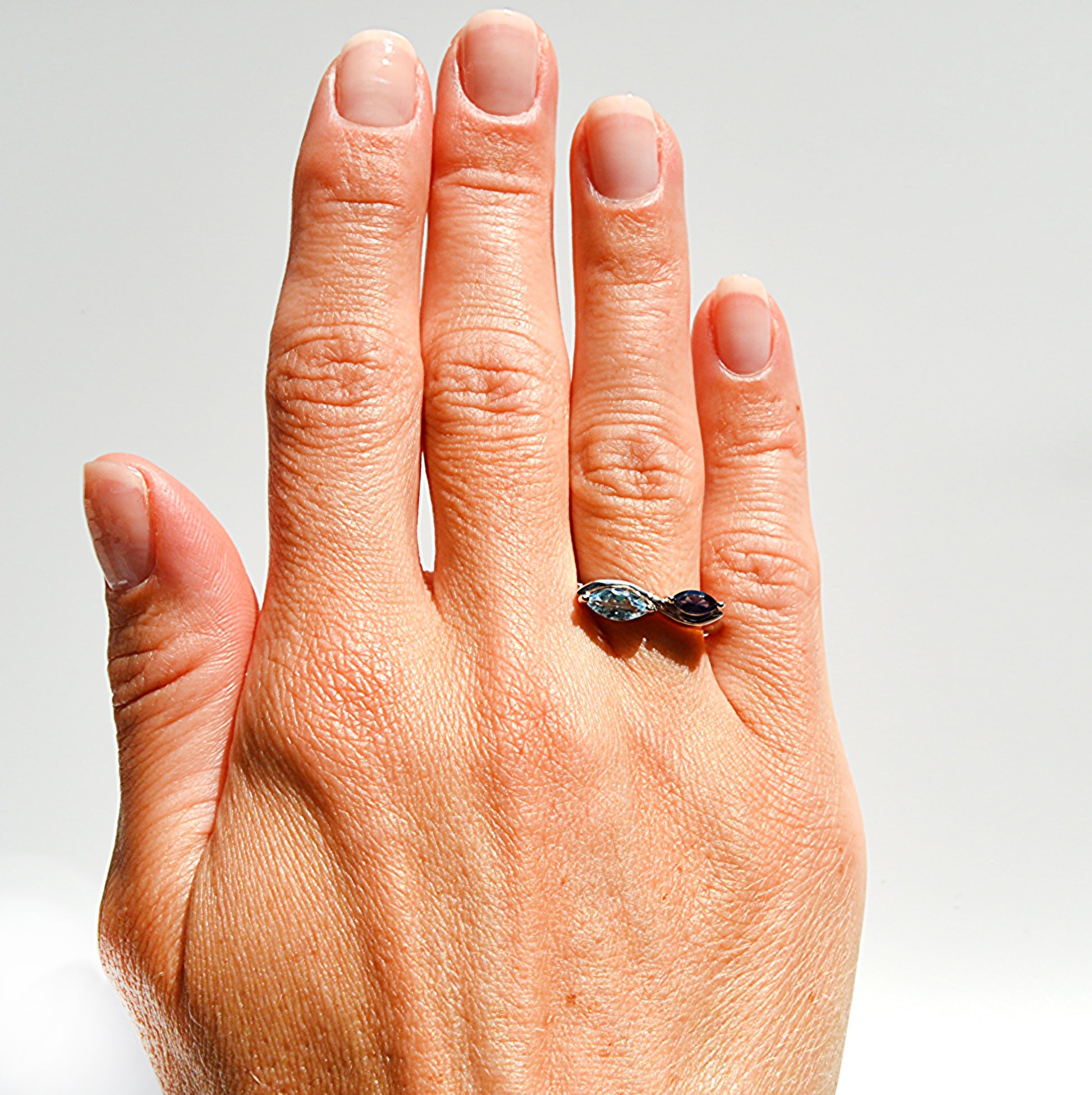 JeniMarie Jewelry with a stunning two stone design ring. Set in sterling silver this ring showcases a blue topaz and tanzanite combination. 