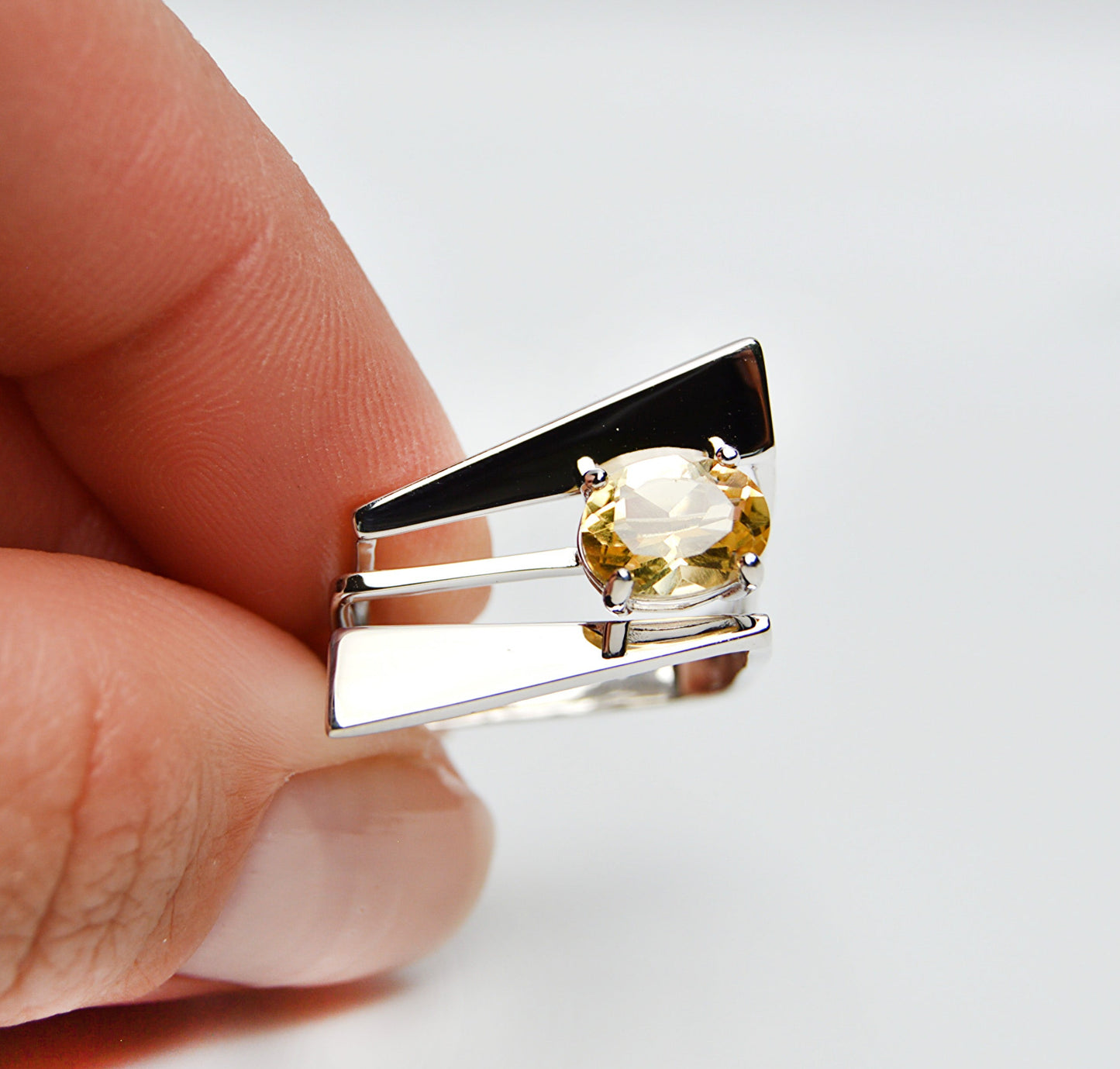 JeniMarie Jewelry with a statement ring showcasing a yellow citrine stone prong set on a multi band ring set in sterling silver. 