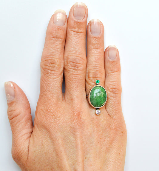 Large and rare emerald quartz ring with accented tube set stones. Fine silver bezel with a textured band.