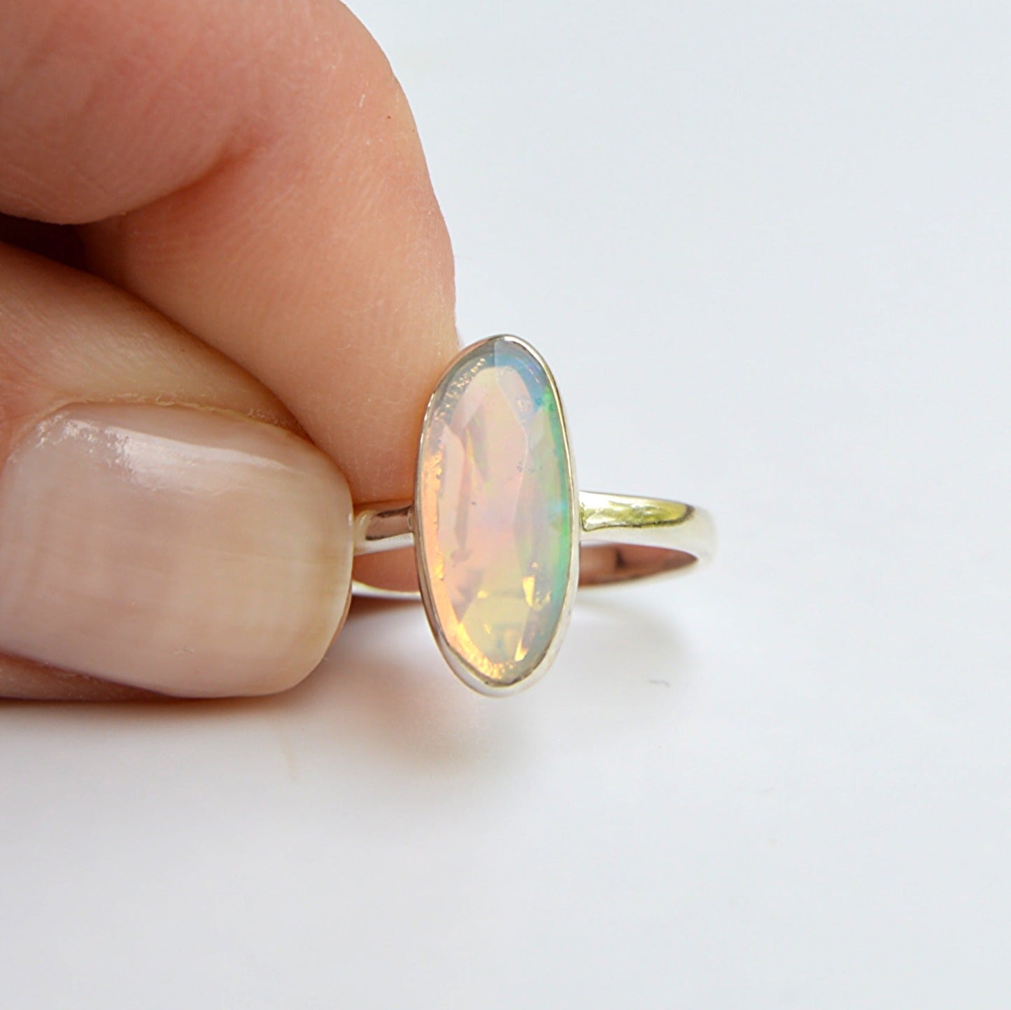 JeniMarie Jewelry presents a faceted ethiopian opal set in .925 sterling silver. Comfort band and hypoallergenic. 
