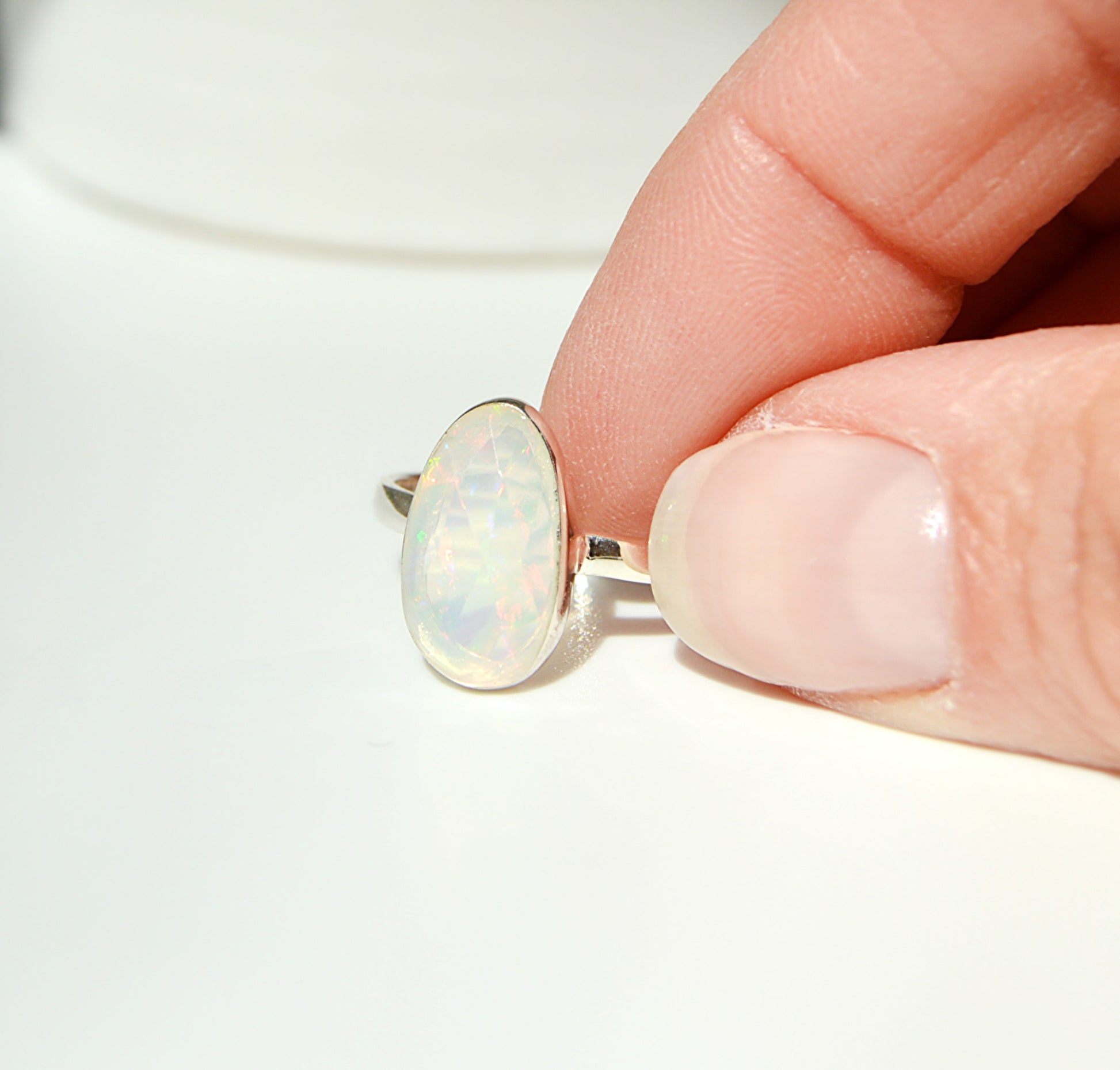 Handset Ethiopian Opal this is a large unique faceted stone set in sterling silver bezel with a high polish shine. 