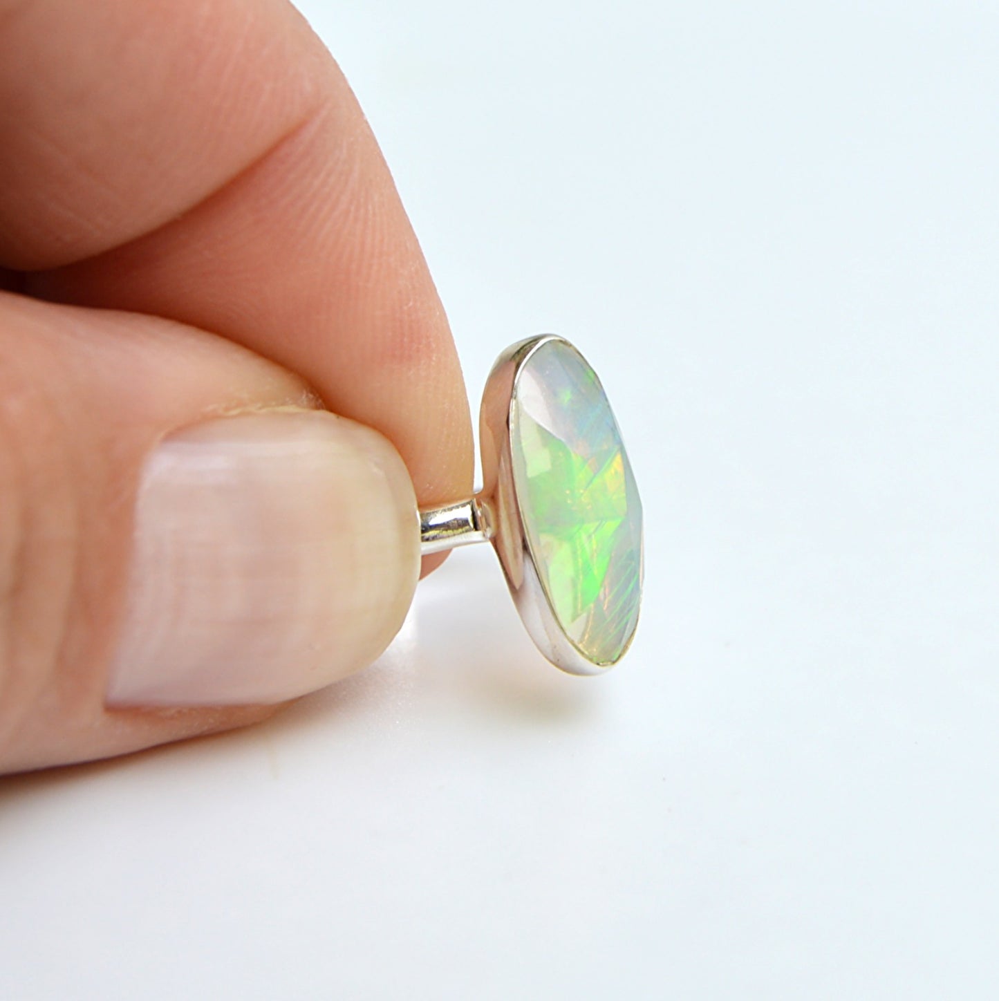JeniMarie Jewelry with a large rare faceted Ethiopian opal ring. Expertly handcrafted with .925 sterling silver. 