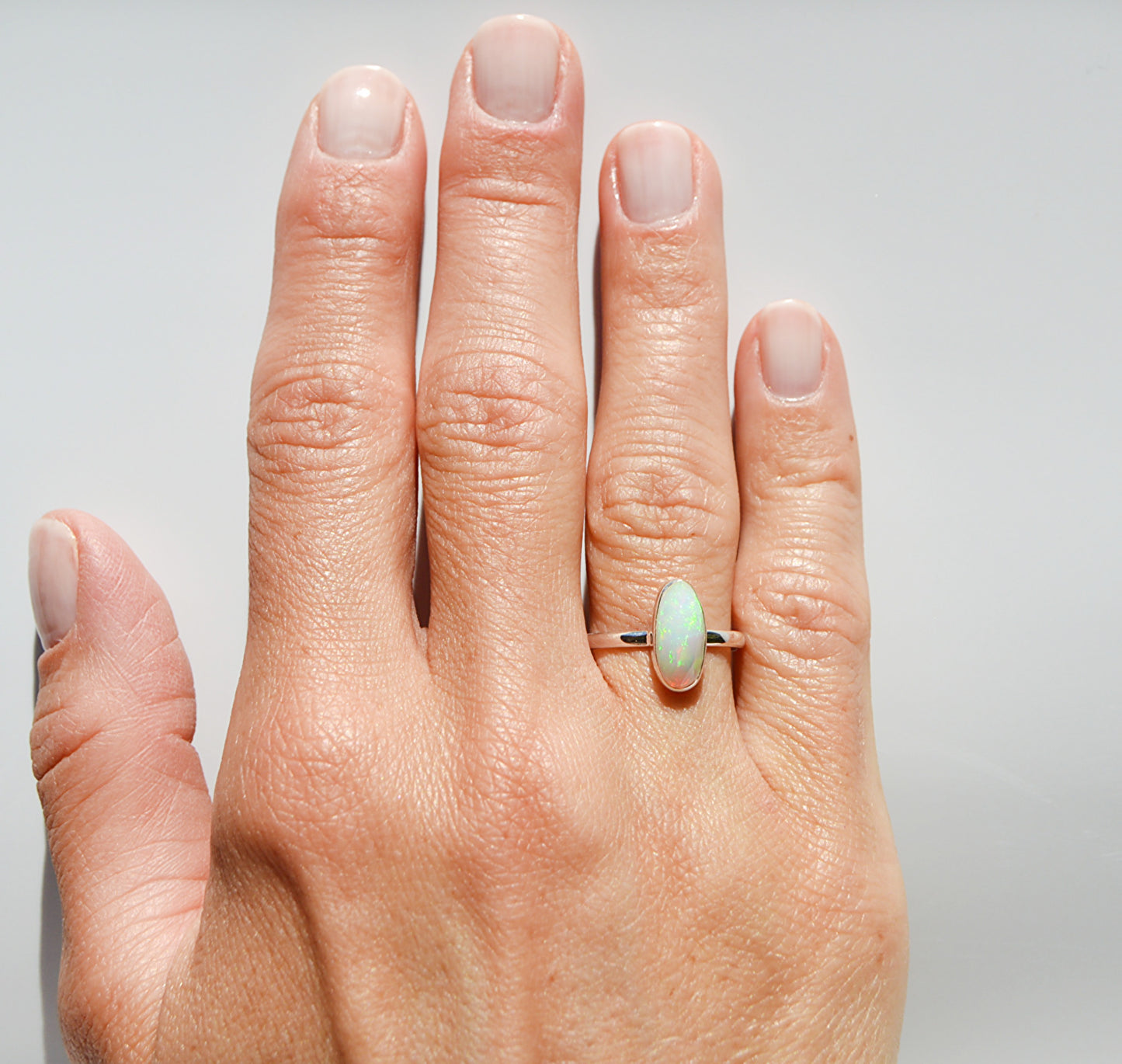JeniMarie Jewelry shows an Ethiopian Opal ring expertly set in .925 sterling silver making the ring hypoallergenic. 