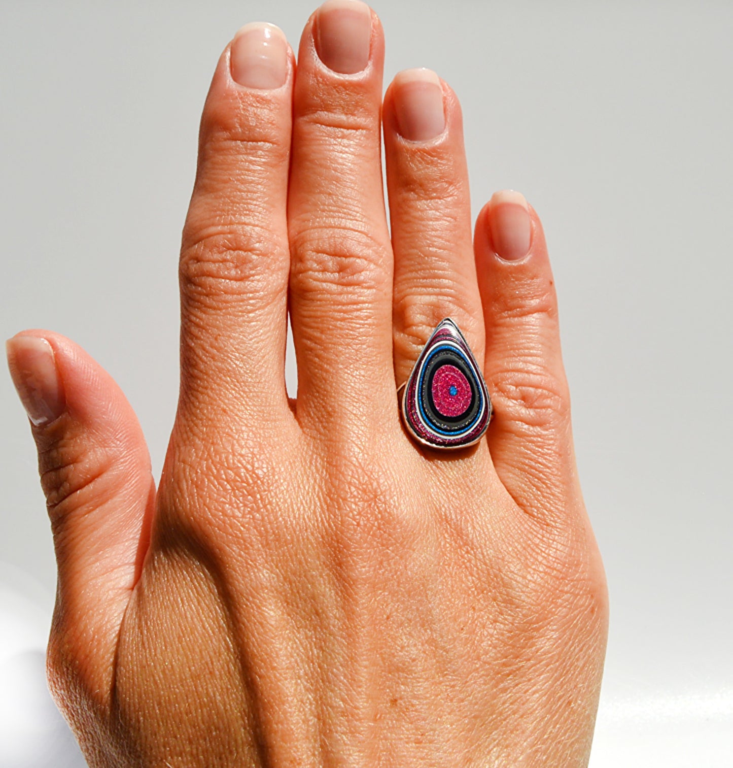 JeniMarie Jewelry with a rare pink and blue fordite stone set in sterling silver with a high polish. 