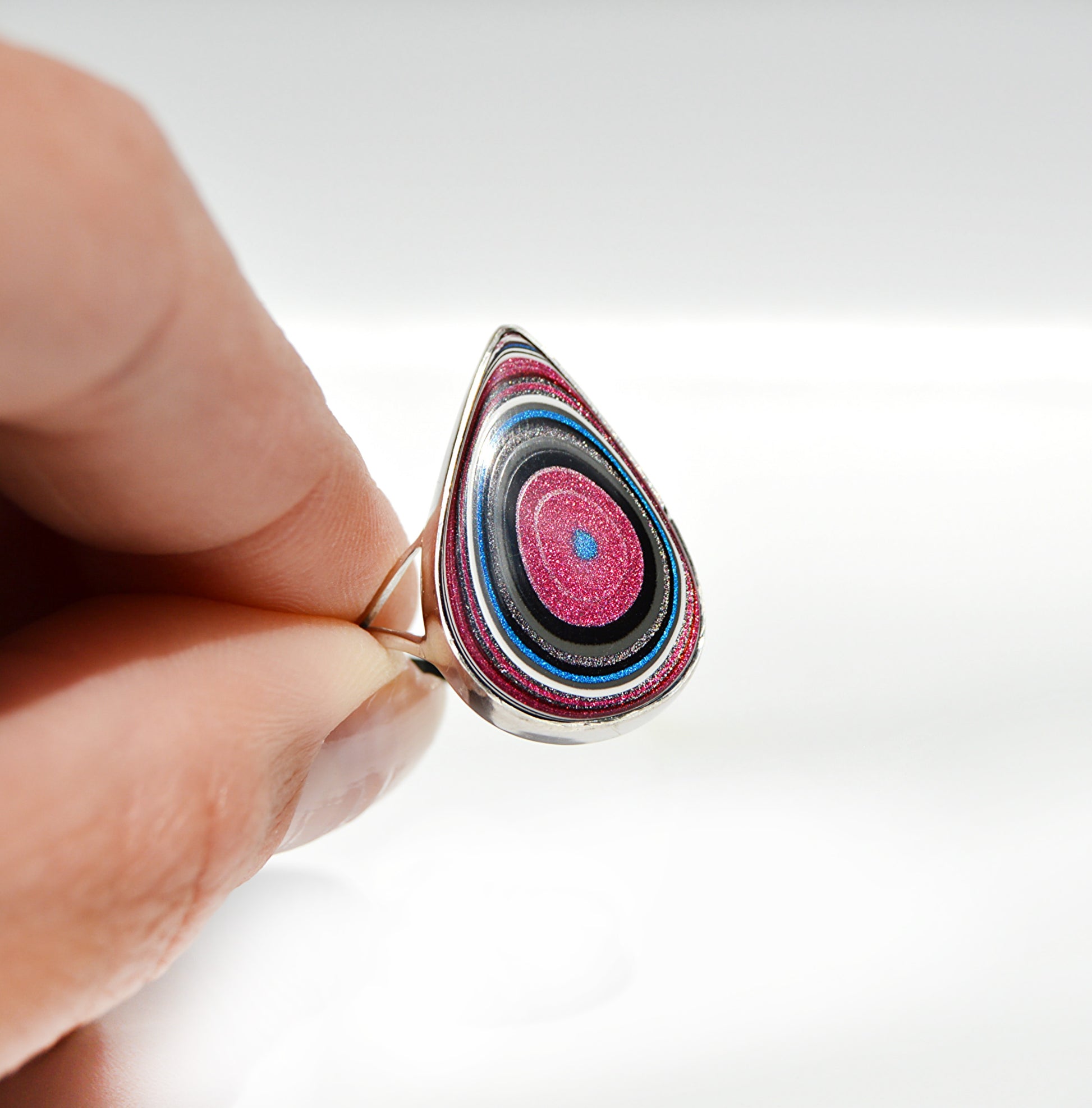 JeniMarie Jewelry featuring a unique fordite ring with rare pink and blue colors. 