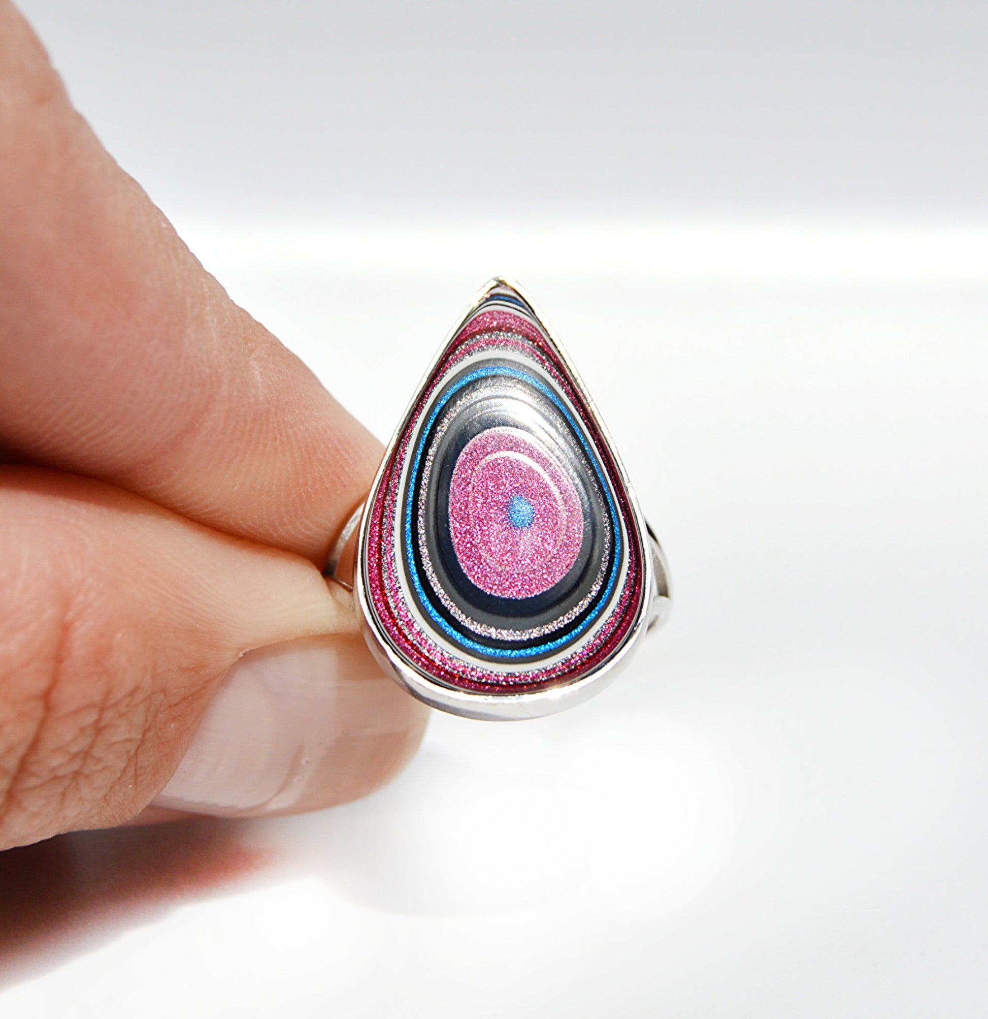 JeniMarie Jewelry with a handcrafted fordite ring with a rare pink and blue stone. 