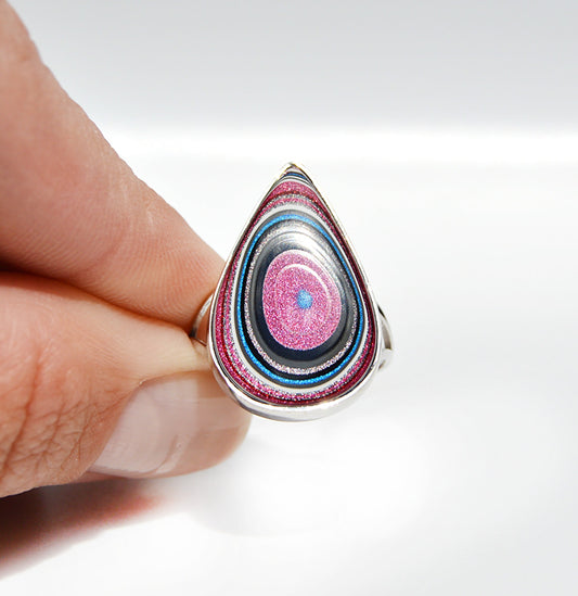 JeniMarie Jewelry with a handcrafted fordite ring with a rare pink and blue stone. 