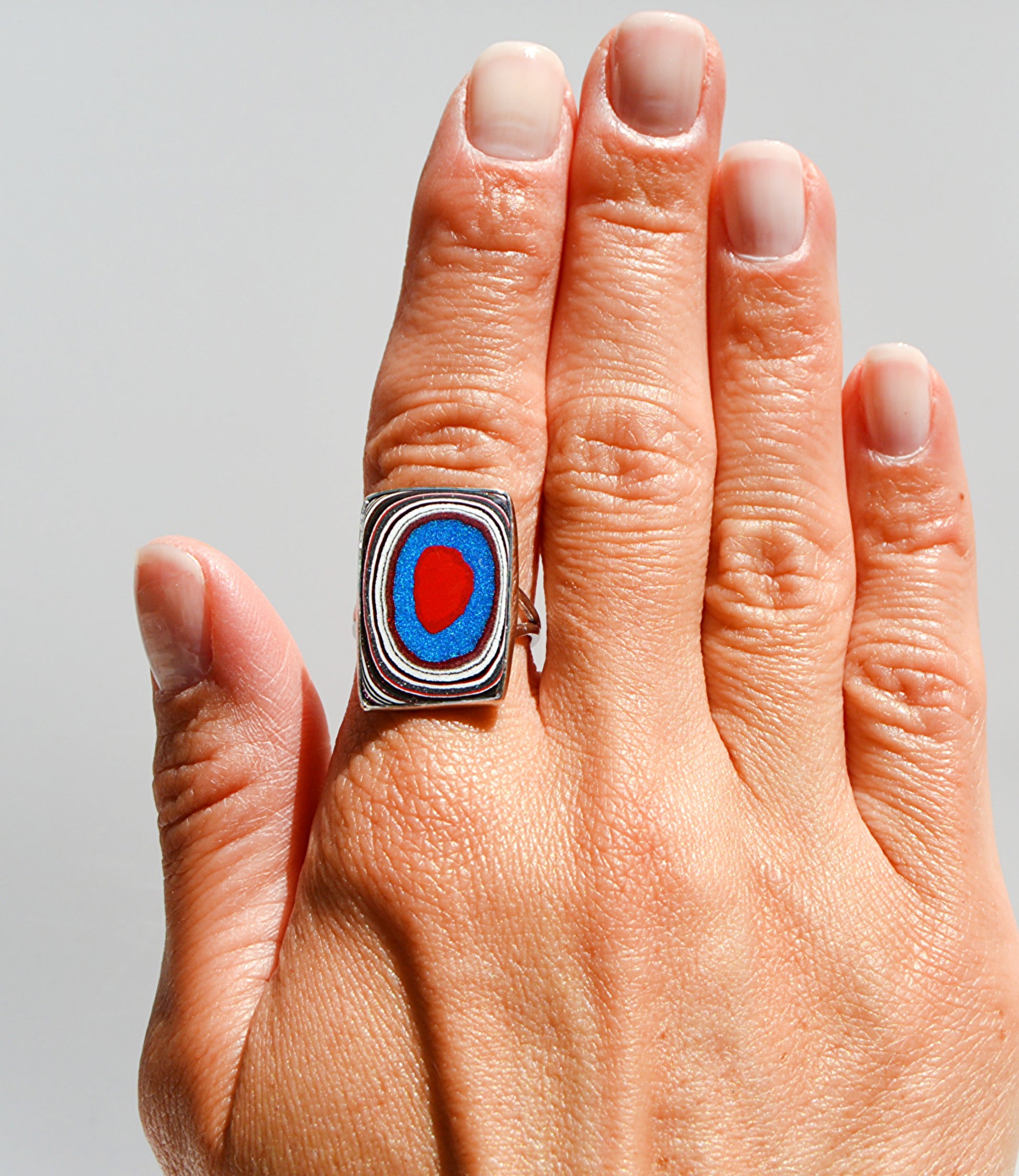Jeniarie Jewelry with a sterling silver ring with a comfort band and a rectangle fordite ring. 