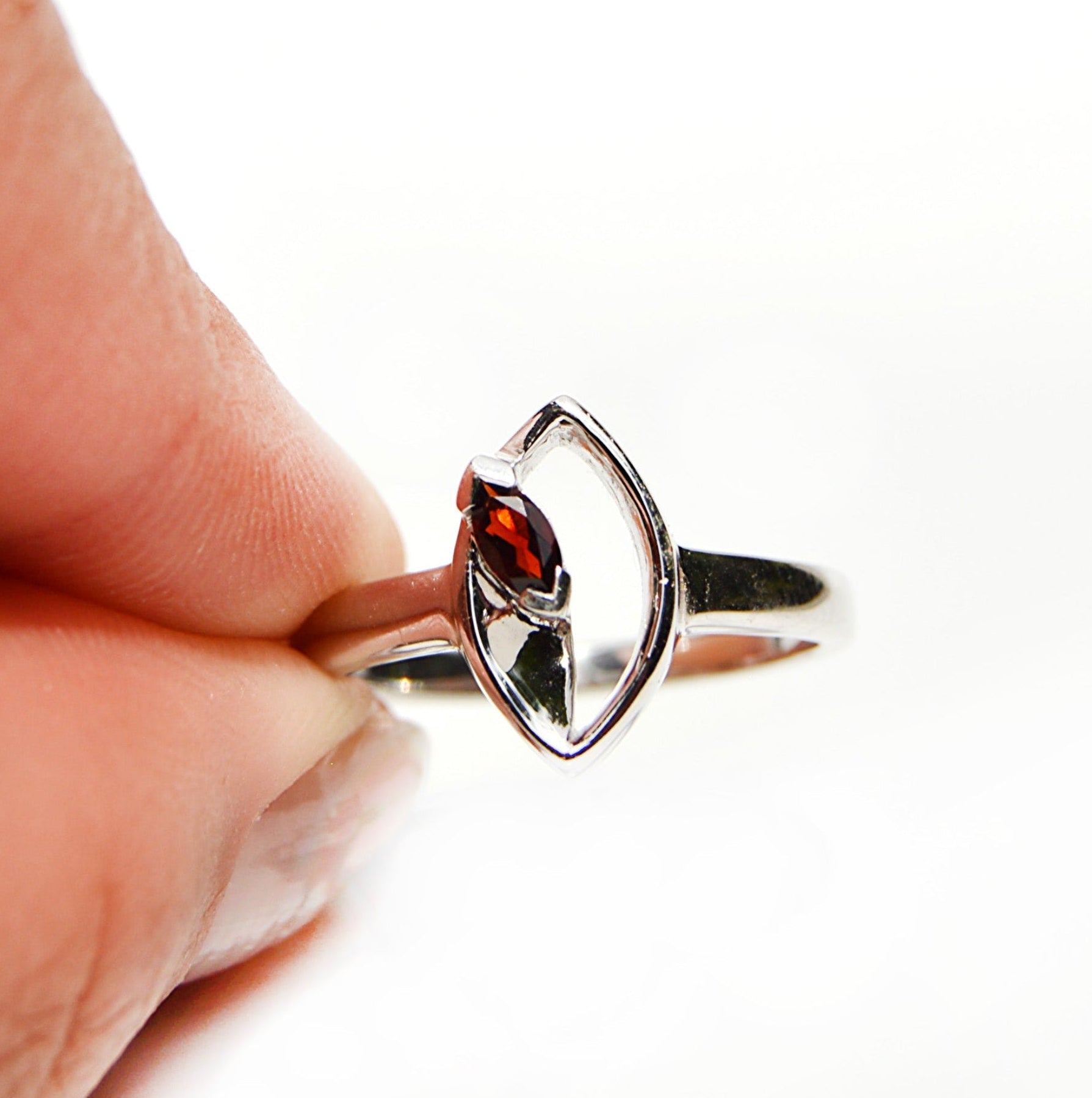 JeniMarie Jewelry with a handcrafted sterling silver ring with a garnet stone. 