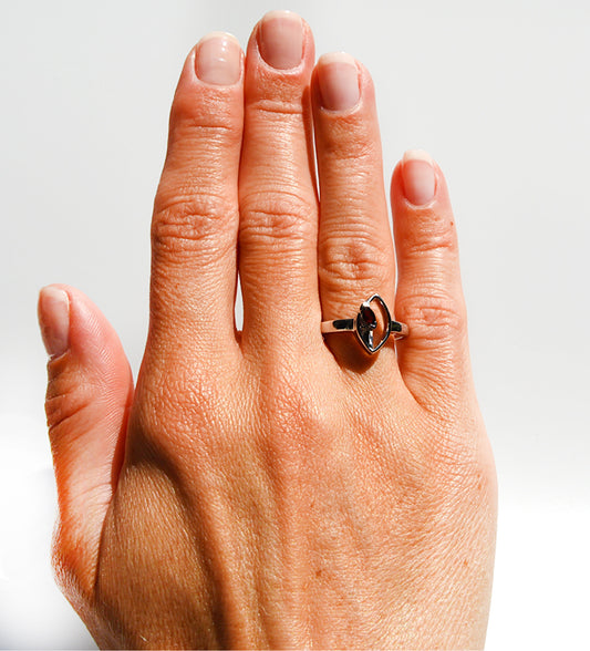 JeniMarie Jewelry with a statement ring featuring a red garnet stone and a comfort fit band all while having a unique setting. 