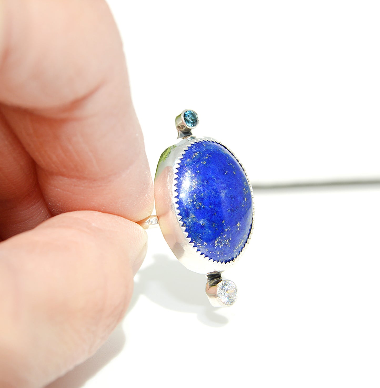 Rare and custom lapis ring with accent stones. Unique piece with a fine silver bezel and textured band