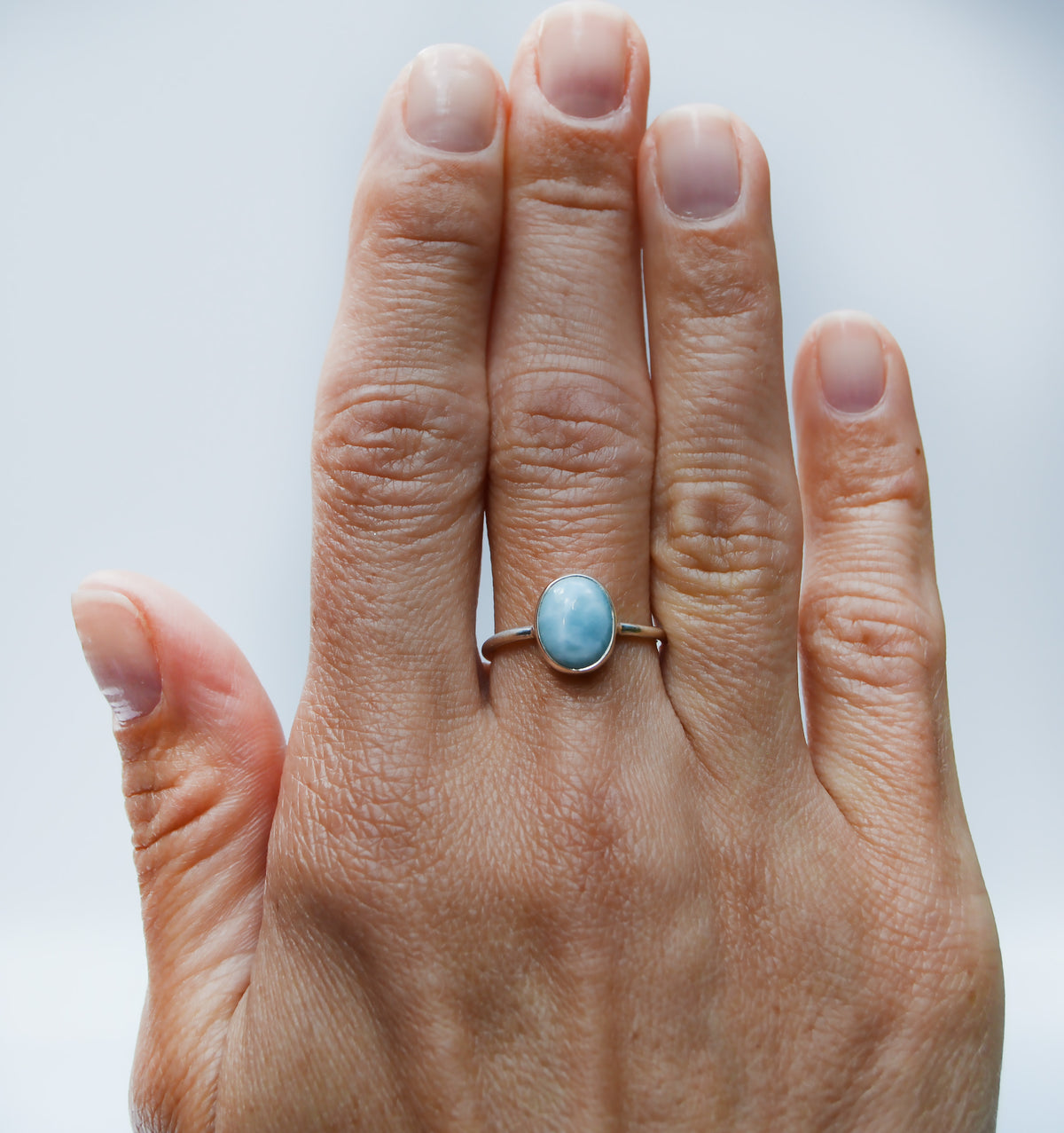 JeniMarie Jewelry with a oval light blue and spotted white larimar stone expertly set in sterling silver. 