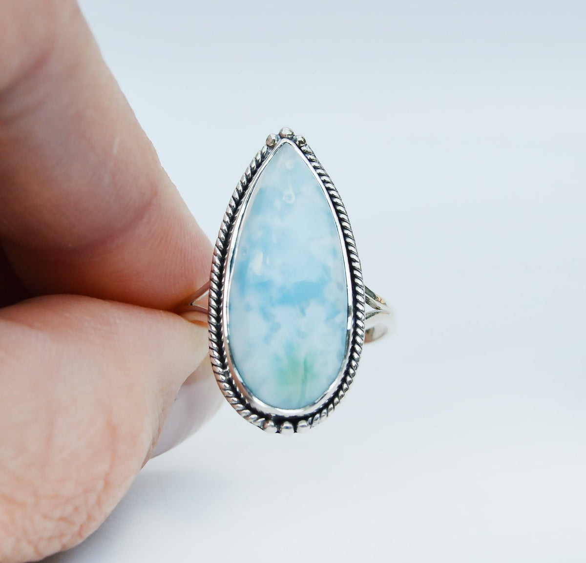 JeniMarie Jewelry with a stunning pear shaped larimar stone set in sterling silver with a beaded bezel. 