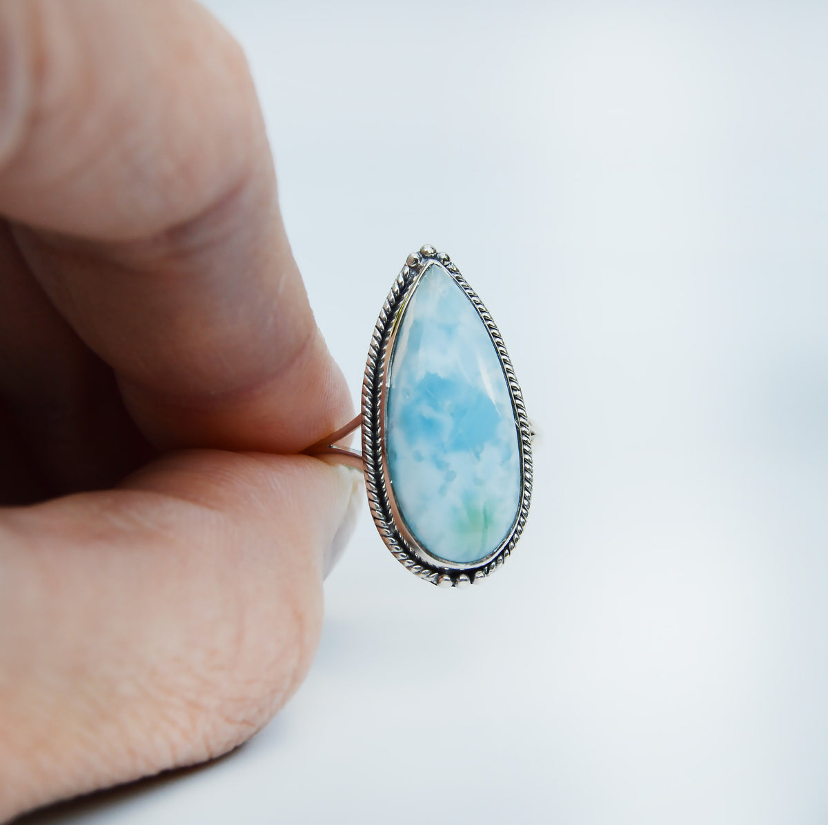 JeniMarie Jewelry with a fun and unique statement ring showcasing a pear shaped larimar stone set in sterling silver. 