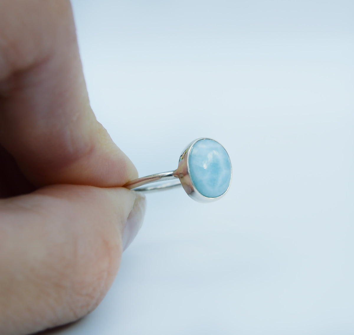 JeniMarie Jewelry with a stunning soft blue hue larimar oval stone set in sterling silver and hand polished for a high shine. 