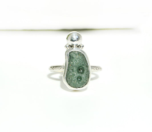 Leelanau Blue stone set in a fine silver bezel with a sterling silver band. 