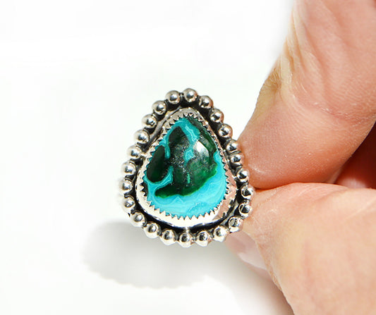 Malacholla ring featuring a unique fine silver bezel and beaded border. .925 silver was used for the band. 